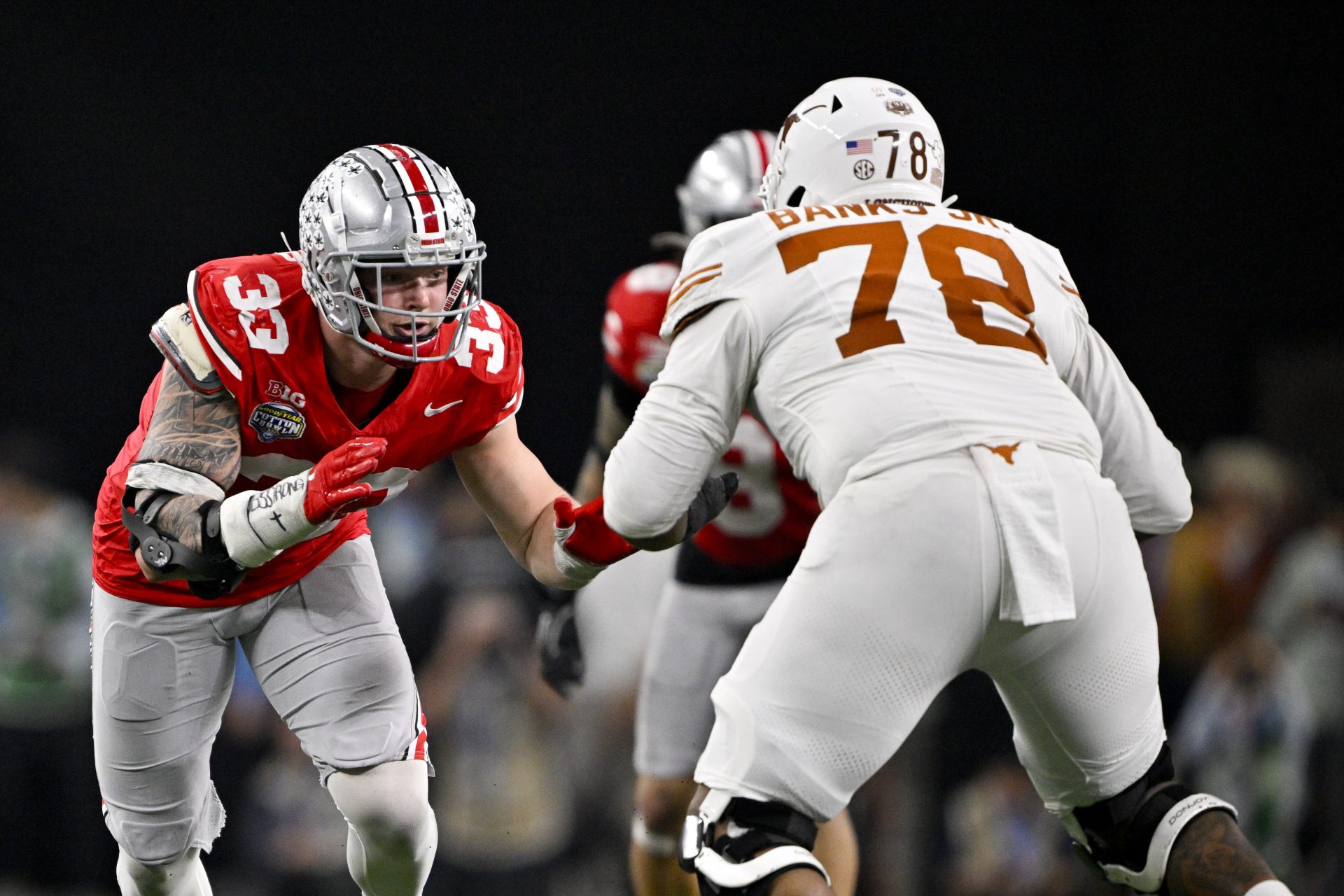 Ohio State Buckeyes defensive end Jack Sawyer (33) rushes against Texas Longhorns offensive lineman Kelvin Banks Jr. (78) during the game at AT&T Stadium.