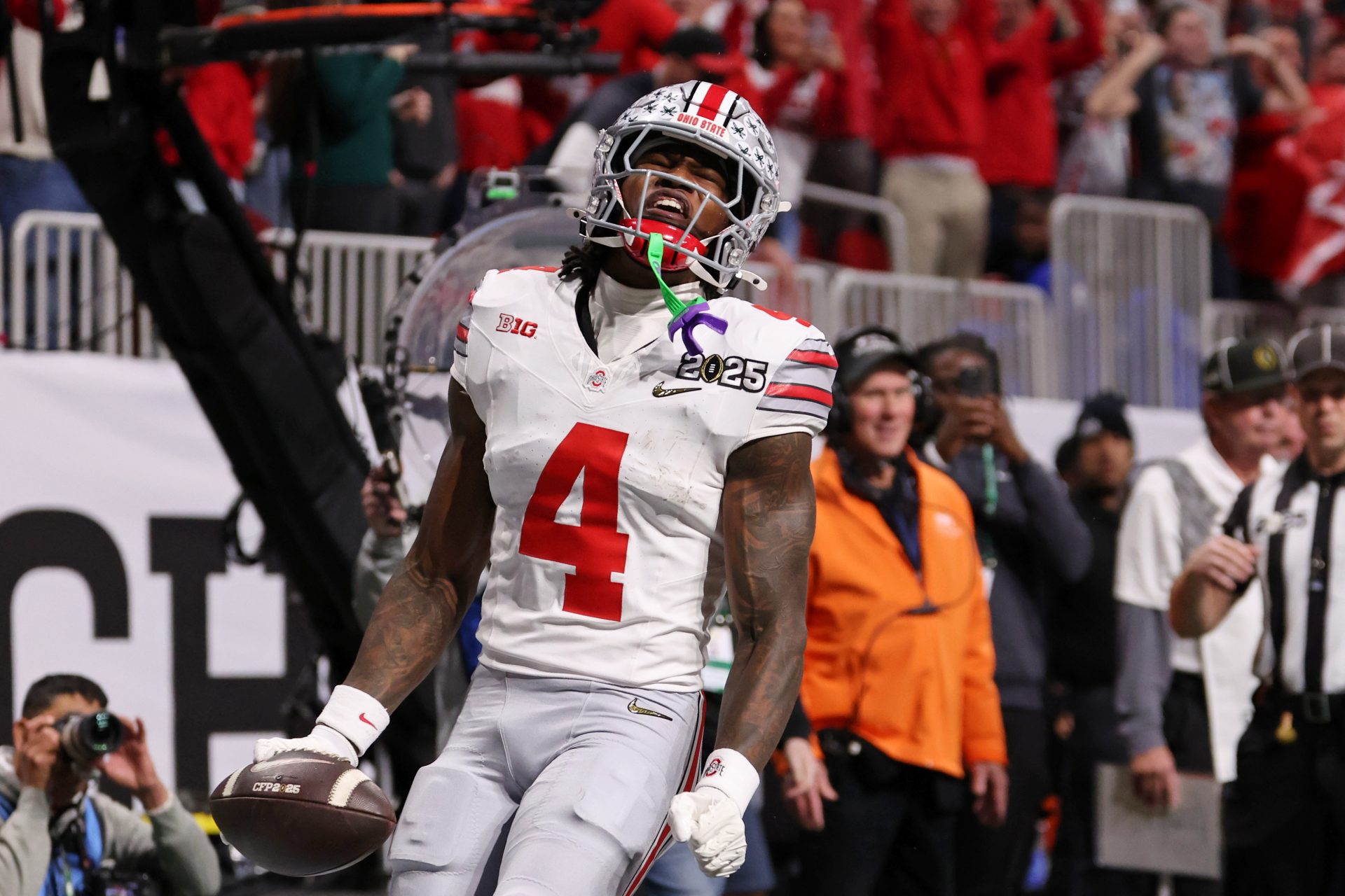 Ohio State Buckeyes wide receiver Jeremiah Smith (4) reacts after scoring against the Notre Dame Fighting Irish a touchdown during the first half the CFP National Championship college football game at Mercedes-Benz Stadium.