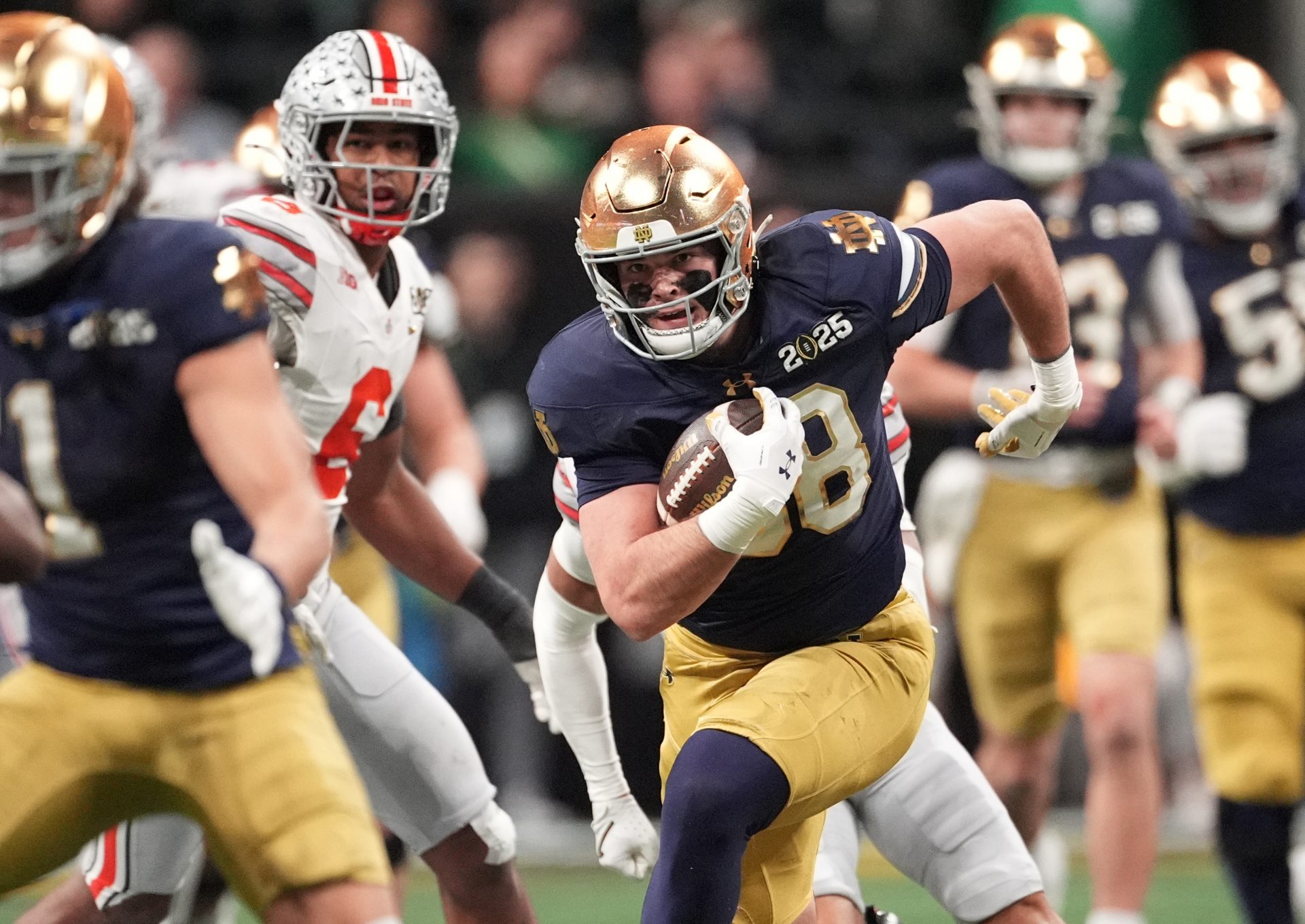 Notre Dame Fighting Irish tight end Mitchell Evans (88) runs after a catch against the Ohio State Buckeyes in the second half in the CFP National Championship college football game at Mercedes-Benz Stadium.