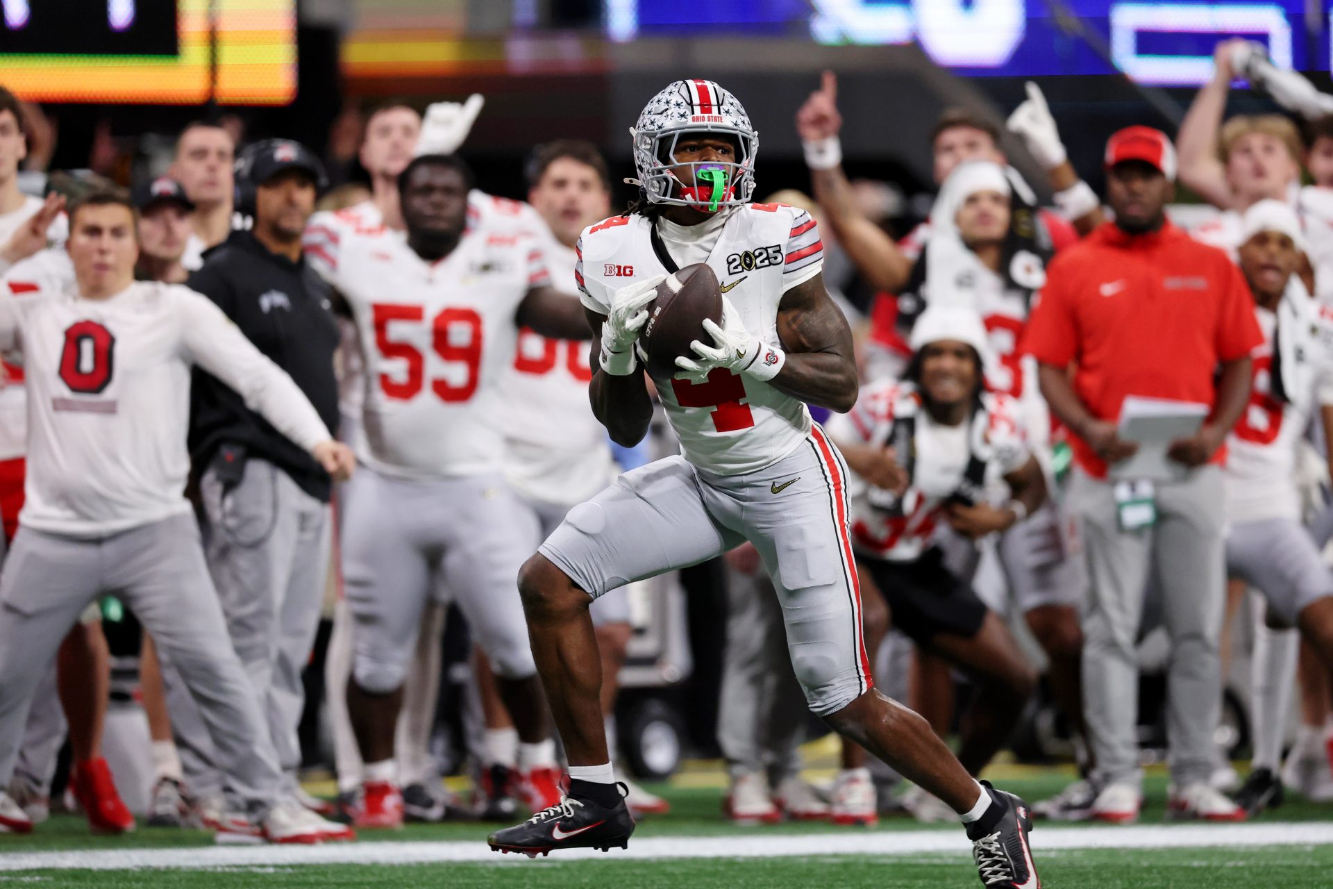 Ohio State Buckeyes wide receiver Jeremiah Smith (4) makes a catch against the Notre Dame Fighting Irish during the second half the CFP National Championship college football game at Mercedes-Benz Stadium.