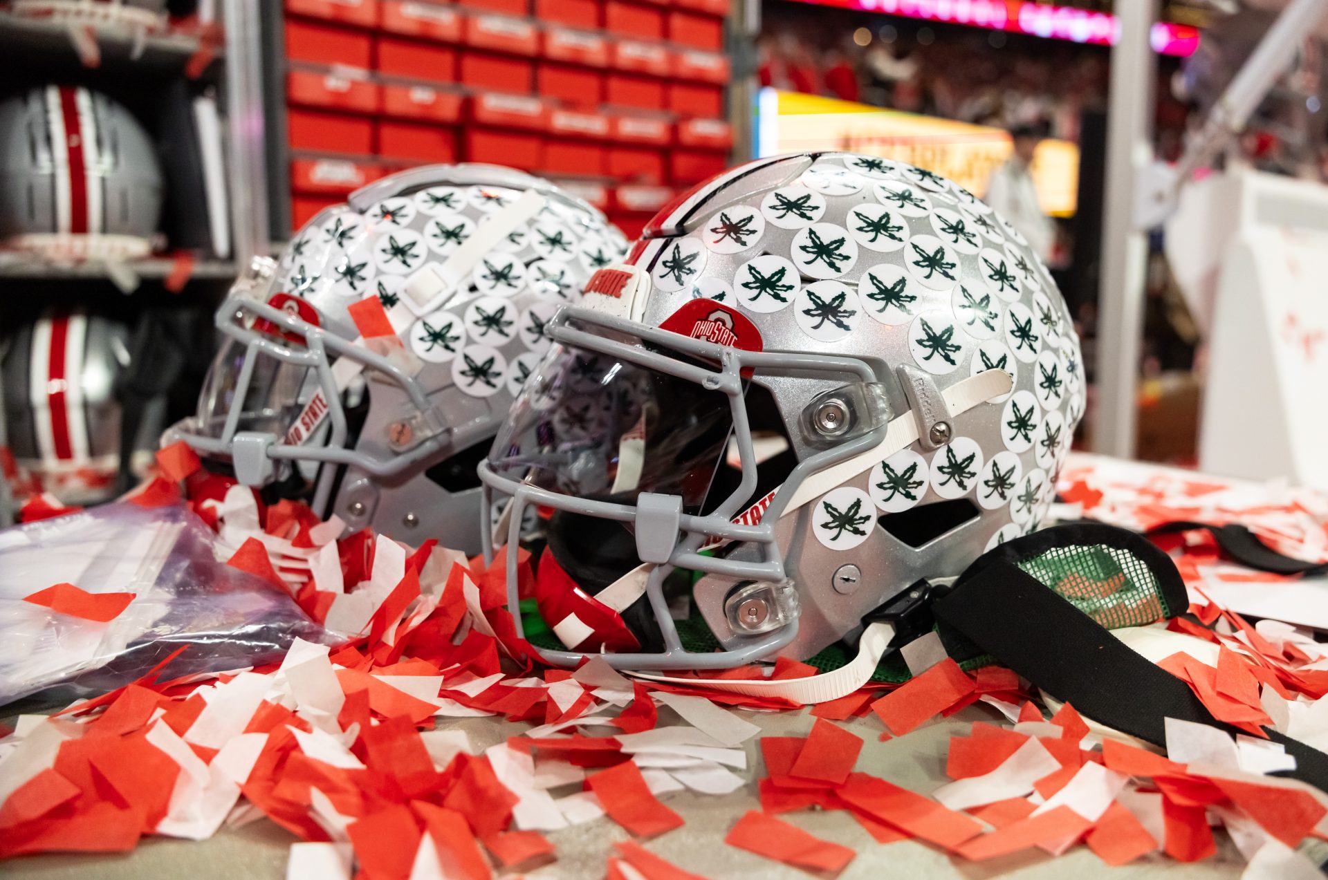 Detailed view of confetti with an Ohio State Buckeyes helmet after winning the CFP National Championship college football game at Mercedes-Benz Stadium.
