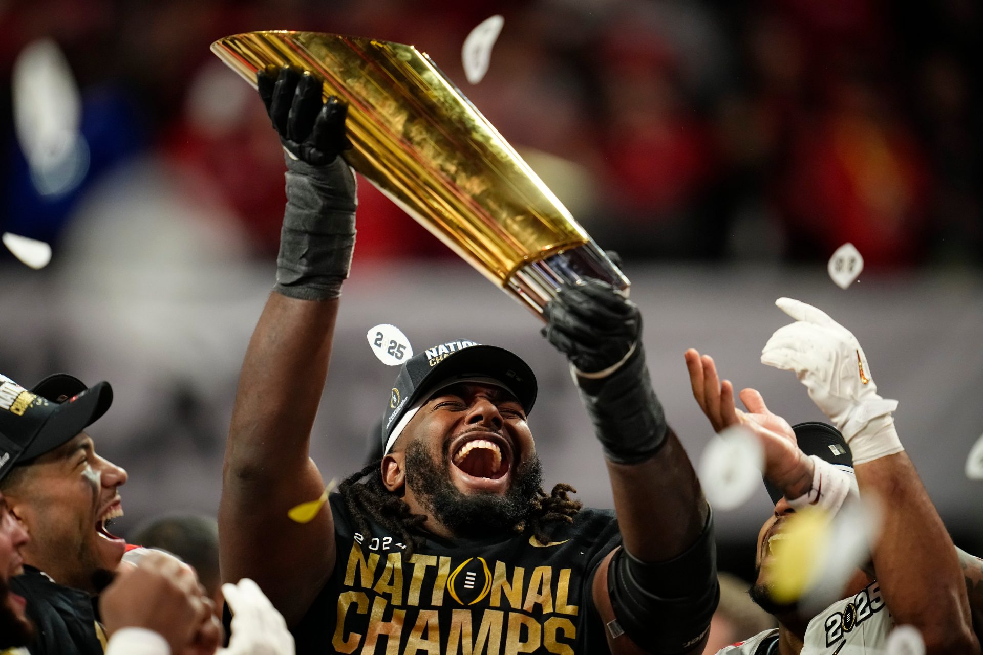 Ohio State Buckeyes wide receiver Jeremiah Smith (4) holds the trophy following the 34-23 win over the Notre Dame Fighting Irish to win the College Football Playoff National Championship at Mercedes-Benz Stadium in Atlanta on Jan. 21, 2025.