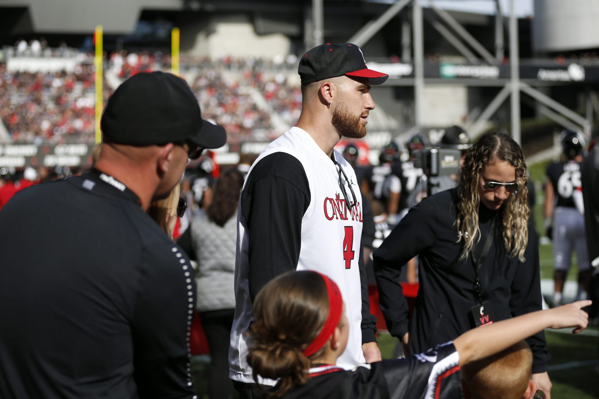 Former UC tight end Travis Kelce walks on the sidelines before the first quarter of the game between the Cincinnati Bearcats and the Tulsa Golden Hurricane at Nippert Stadium on Oct. 19, 2019.