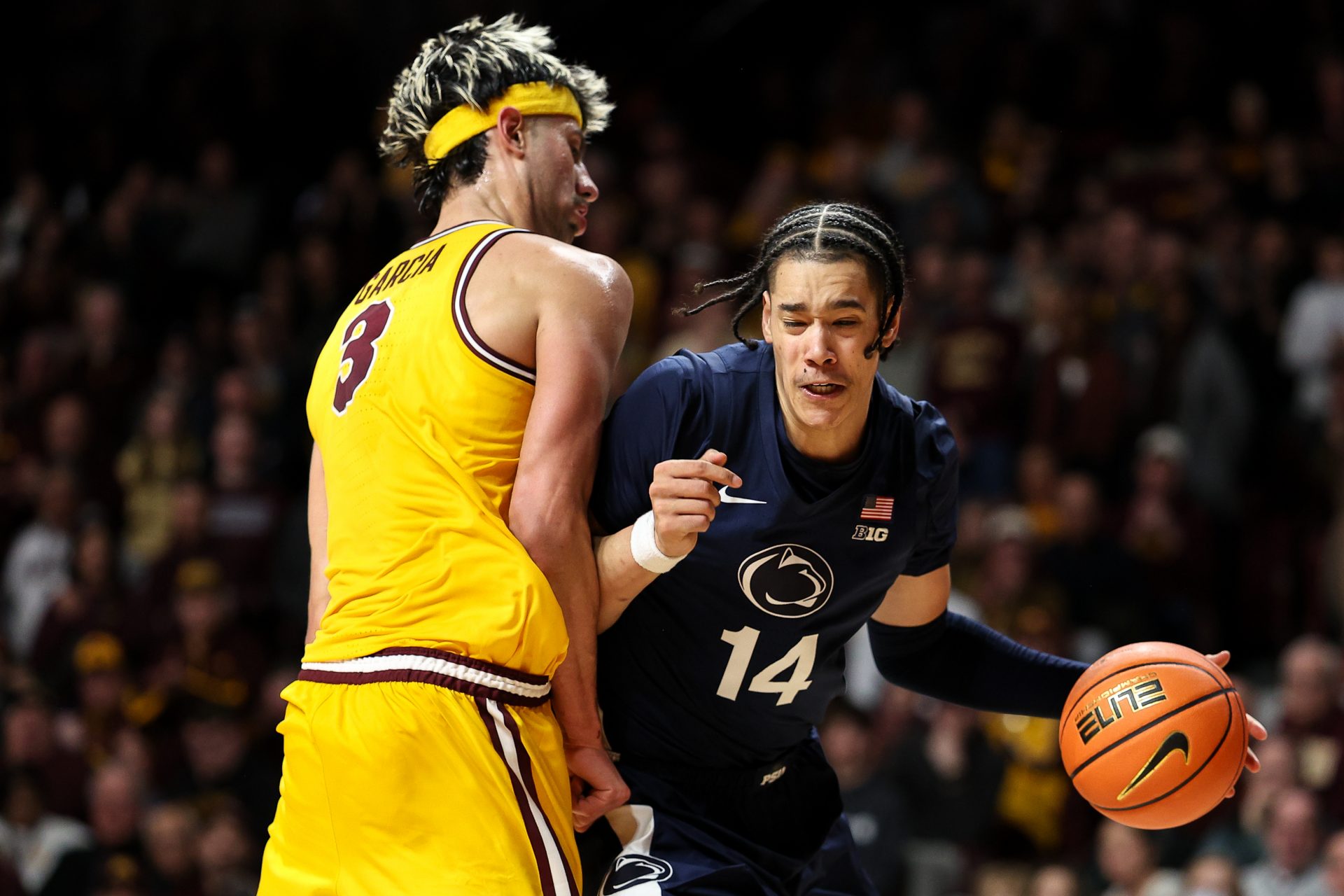 Penn State Nittany Lions forward Yanic Konan Niederhauser (14) works around Minnesota Golden Gophers forward Dawson Garcia (3) during the second half at Williams Arena.