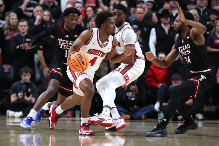 Houston Cougars guard LJ Cryer (4) dribbles the ball against Texas Tech Red Raiders guard Kerwin Walton (24) in the first half at United Supermarkets Arena.