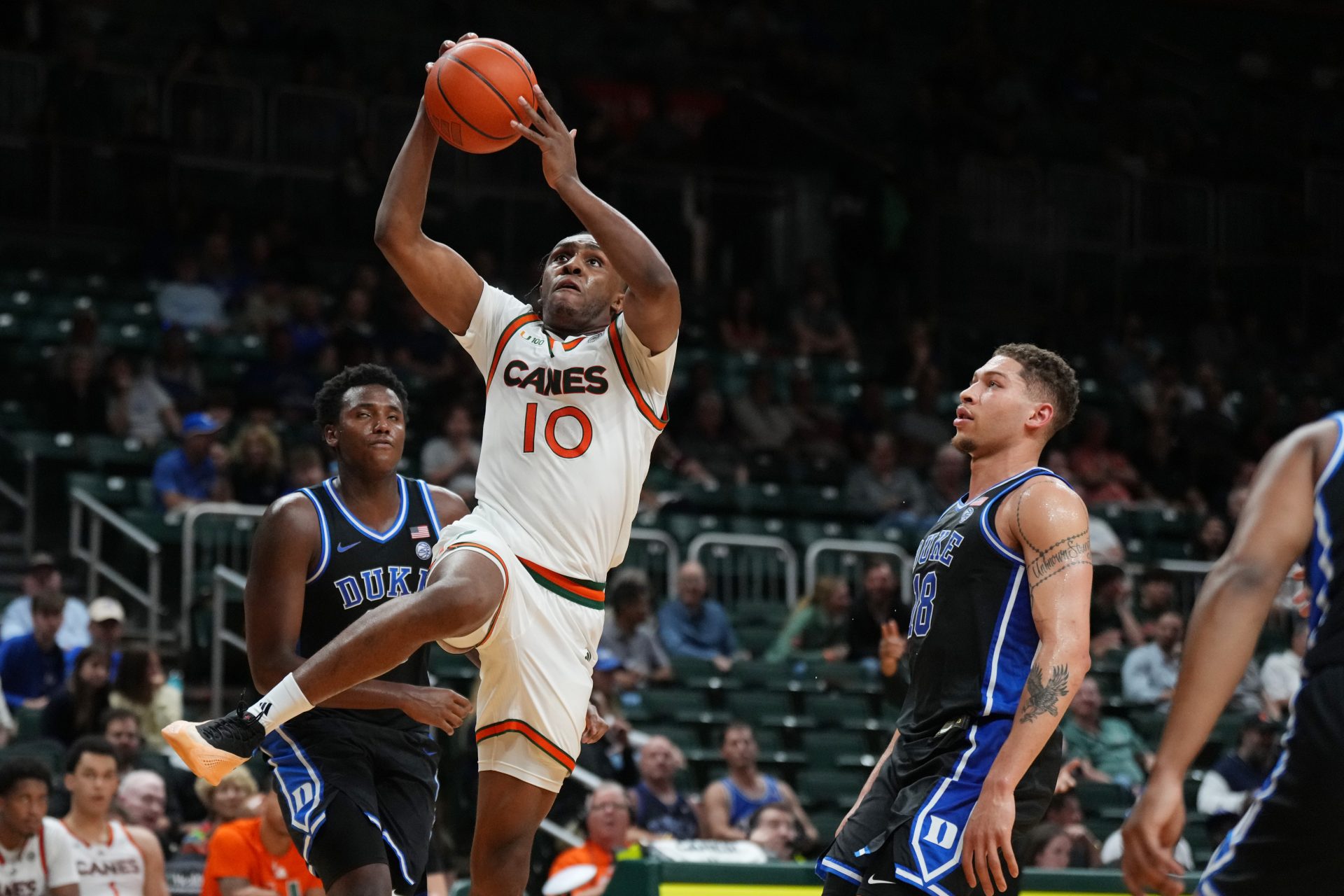 Miami (Fl) Hurricanes guard Paul Djobet (10) splits the defense of Duke Blue Devils center Patrick Ngongba II (21) and forward Mason Gillis (18) during the second half at Watsco Center.
