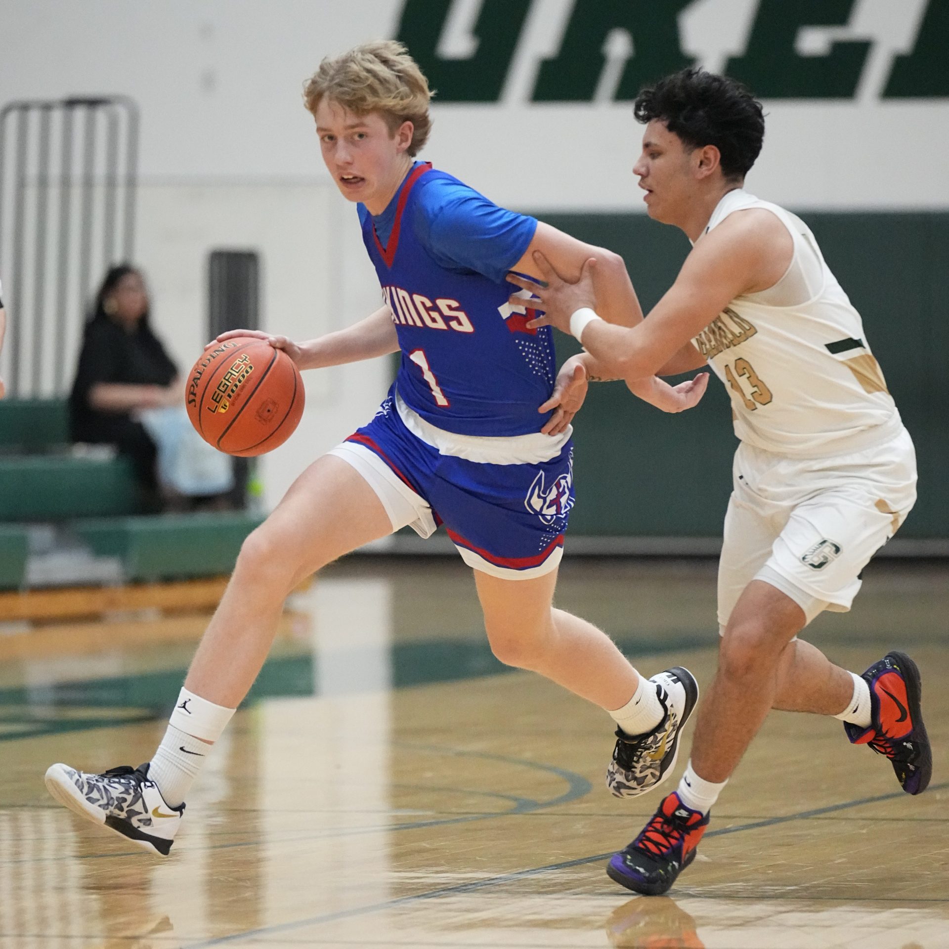 Wisconsin Lutheran's Kager Knueppel (1) works to get past Greenfield's Jayden Valdez (13) during the game at Greenfield, Wednesday, February 26, 2025. Wisconsin Lutheran won the game, 93-59.