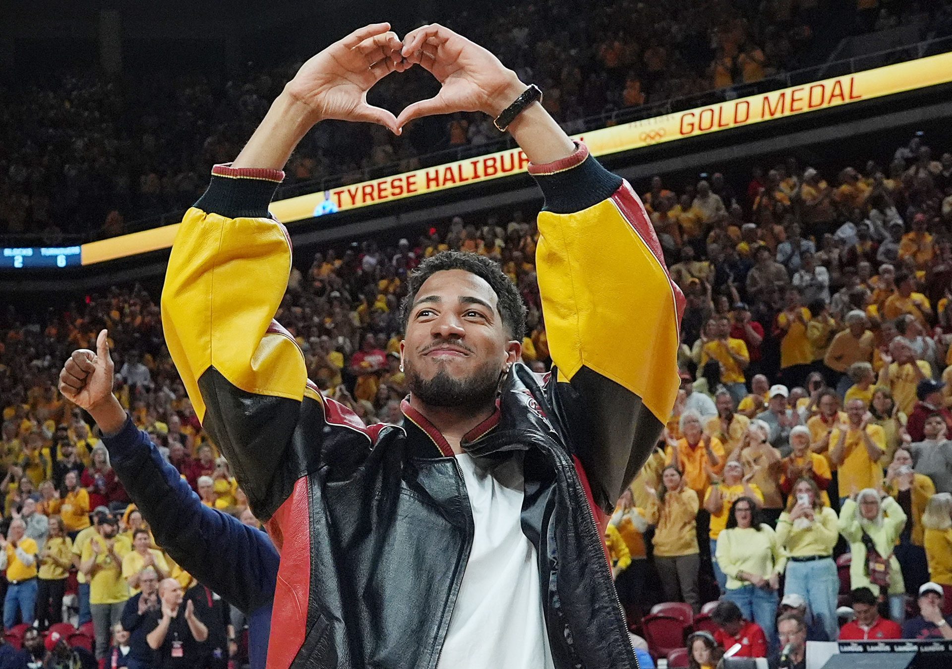 Former Iowa State and Indiana Packer guard Tyrese Haliburton shows heart sign as the unveiling his Olympic 24 gold made banner during the halftime of Cyclones and Wildcats men’s basketball showdown at Hilton Coliseum on Saturday March 1, 2025 in Ames, Iowa.