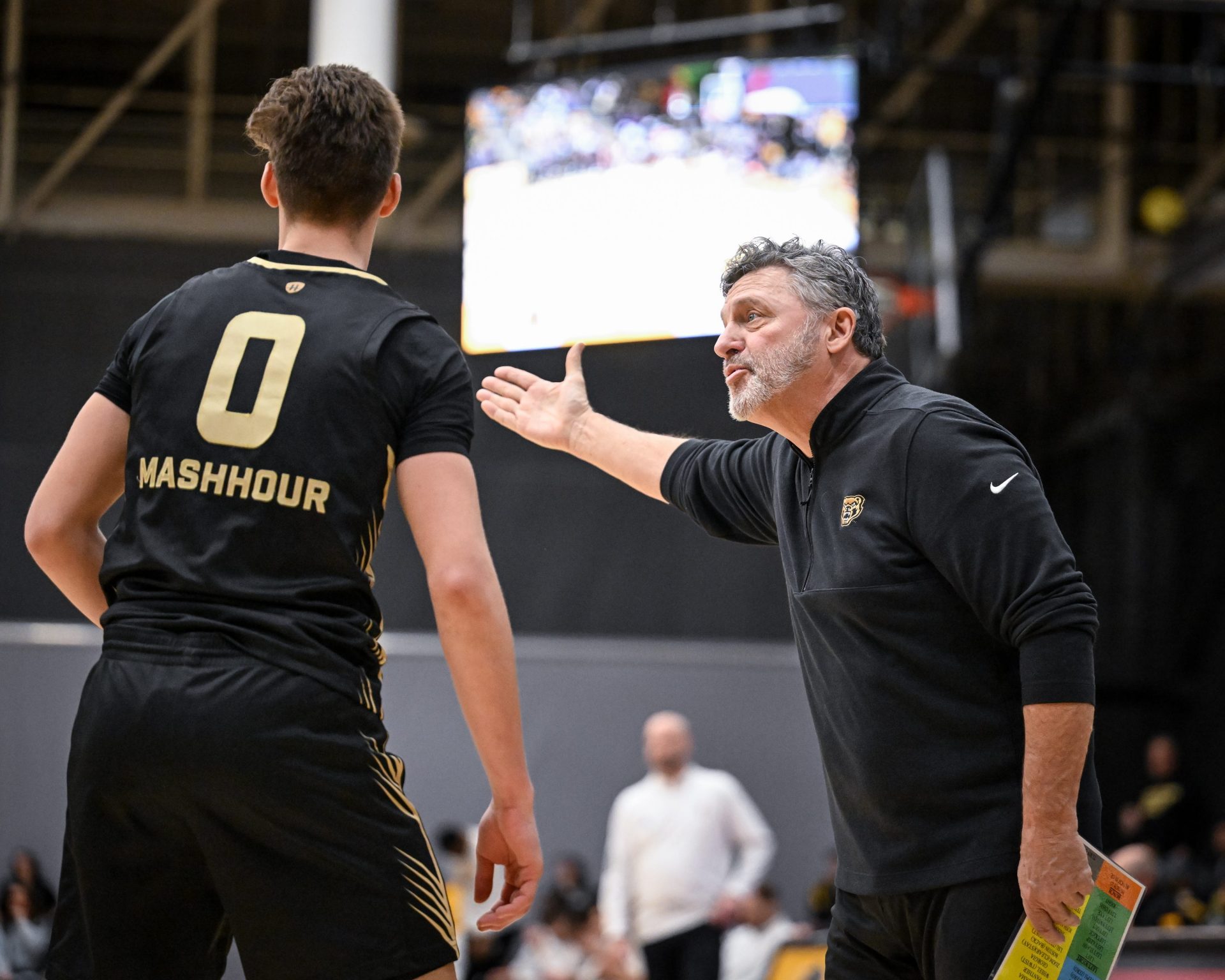Oakland Golden Grizzlies coach Greg Kampe talks with guard Nassim Mashhour (0) during the first half of a Horizon League quarterfinal against the UW-Milwaukee Panthers on Thursday, March 6, 2025, at the Klotsche Center in Milwaukee, Wisconsin.