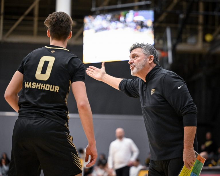 Oakland Golden Grizzlies coach Greg Kampe talks with guard Nassim Mashhour (0) during the first half of a Horizon League quarterfinal against the UW-Milwaukee Panthers on Thursday, March 6, 2025, at the Klotsche Center in Milwaukee, Wisconsin.