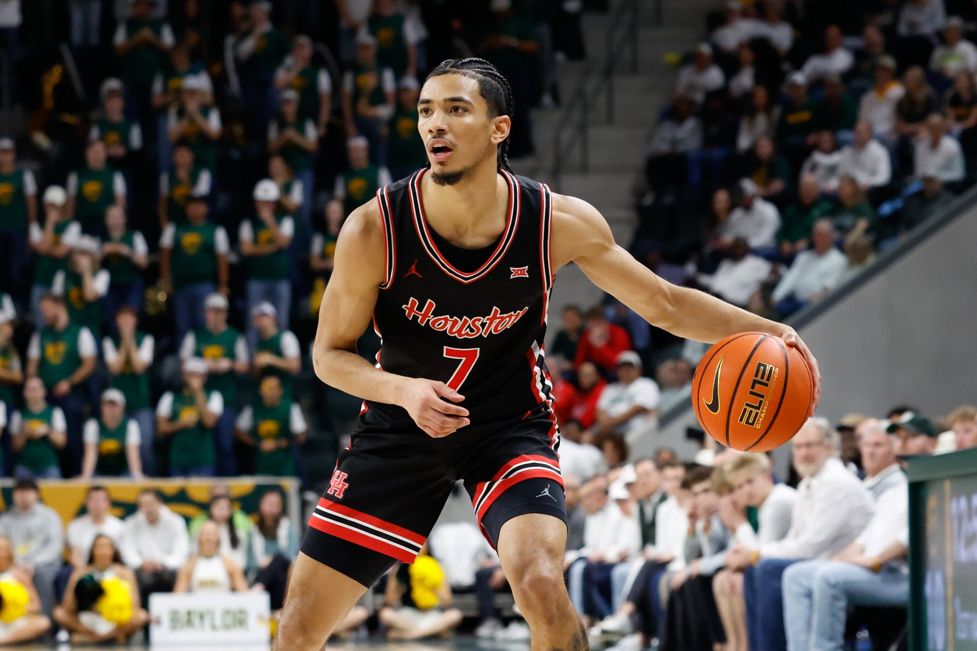 Houston Cougars guard Milos Uzan (7) controls the ball against the Baylor Bears during the first half at Paul and Alejandra Foster Pavilion.