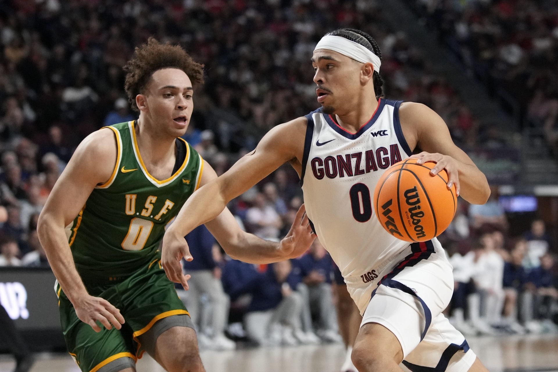 Gonzaga Bulldogs guard Ryan Nembhard (0) dribbles the basketball against San Francisco Dons guard Ryan Beasley (0) during the first half in the semifinal of the West Coast Conference tournament at Orleans Arena.