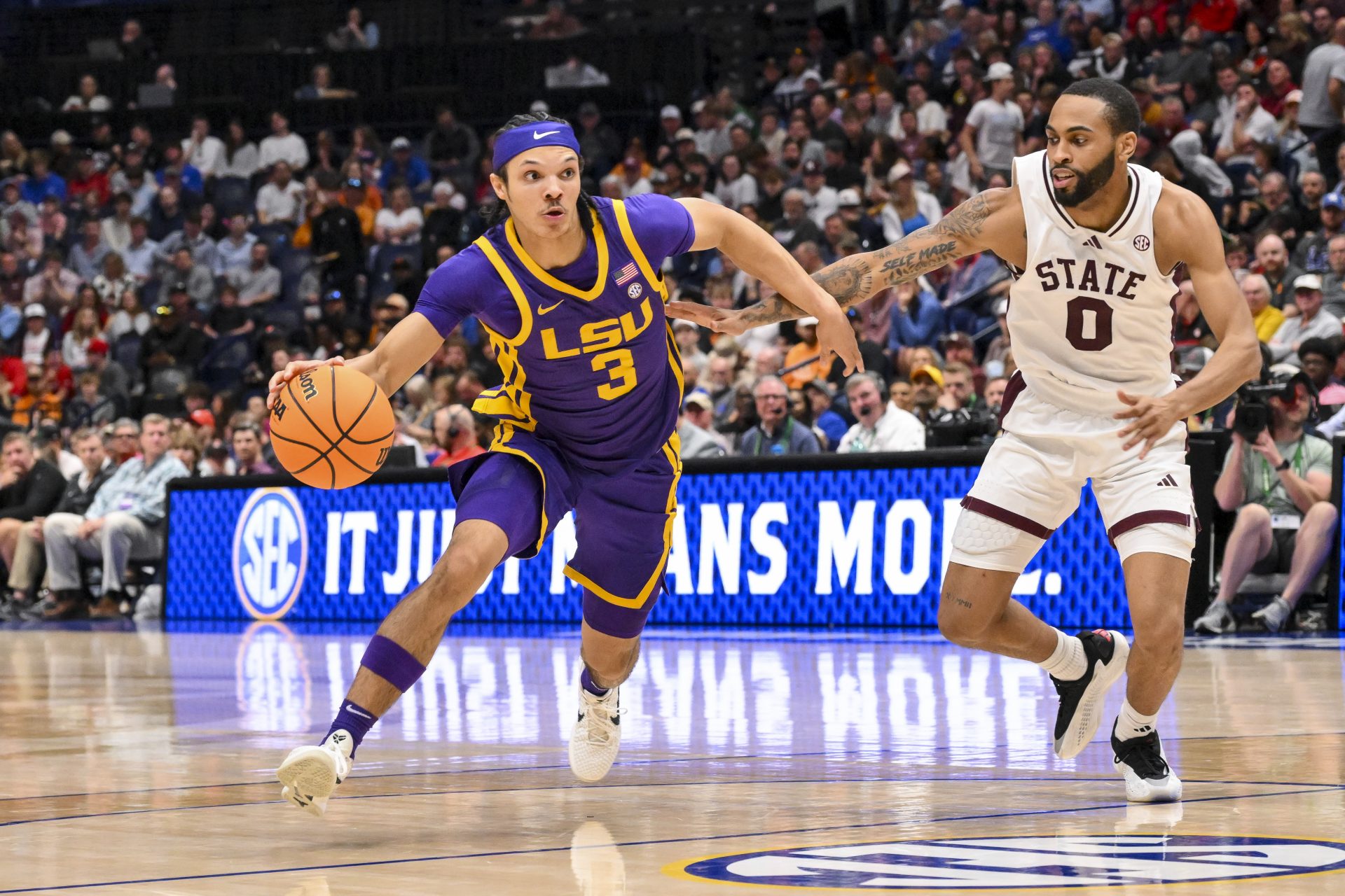 LSU Tigers guard Curtis Givens III (3) dribbles past Mississippi State Bulldogs guard Claudell Harris Jr. (0) during the second half at Bridgestone Arena.