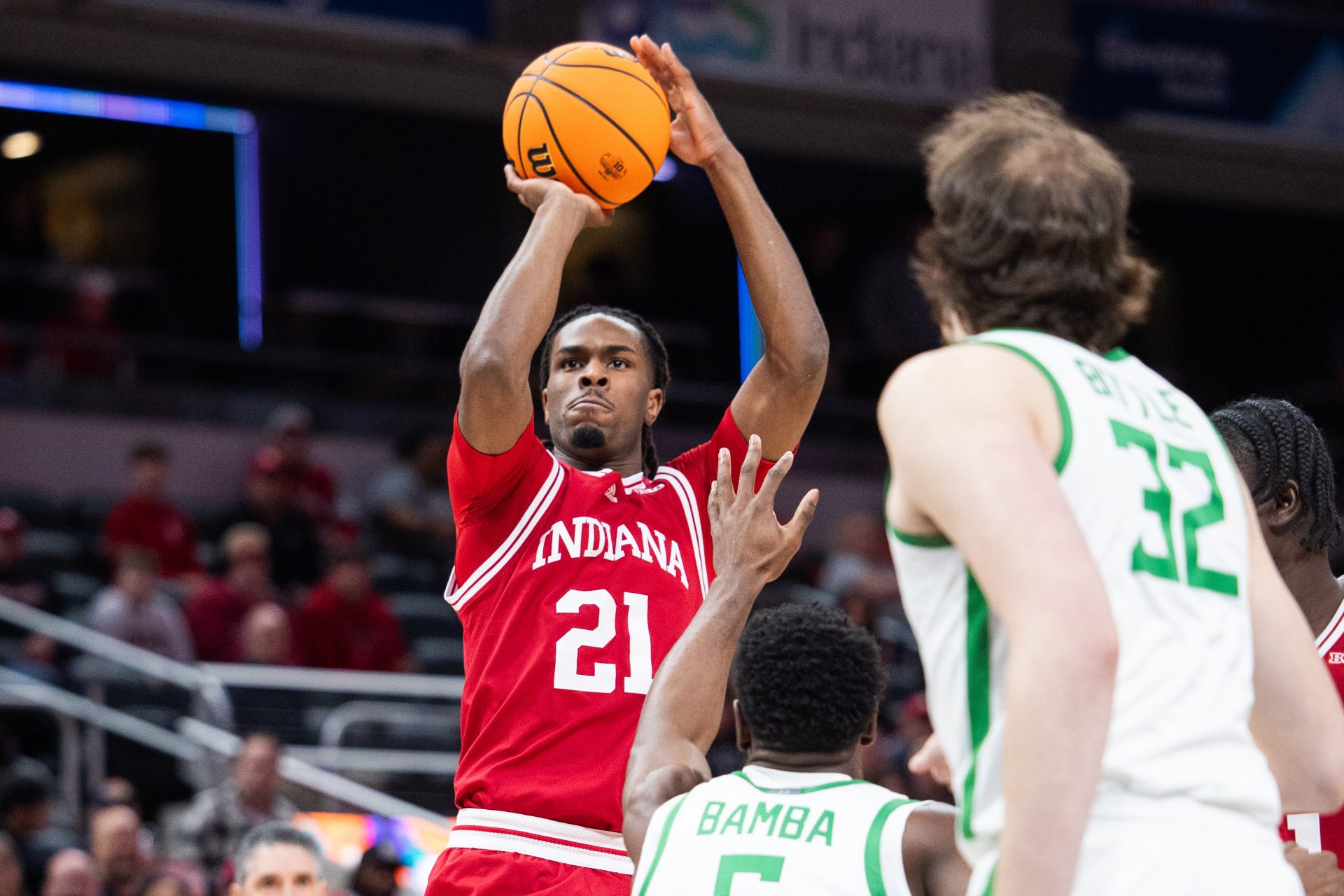 Indiana Hoosiers forward Mackenzie Mgbako (21) shoots the ball while Oregon Ducks guard TJ Bamba (5) defends in the first half at Gainbridge Fieldhouse.