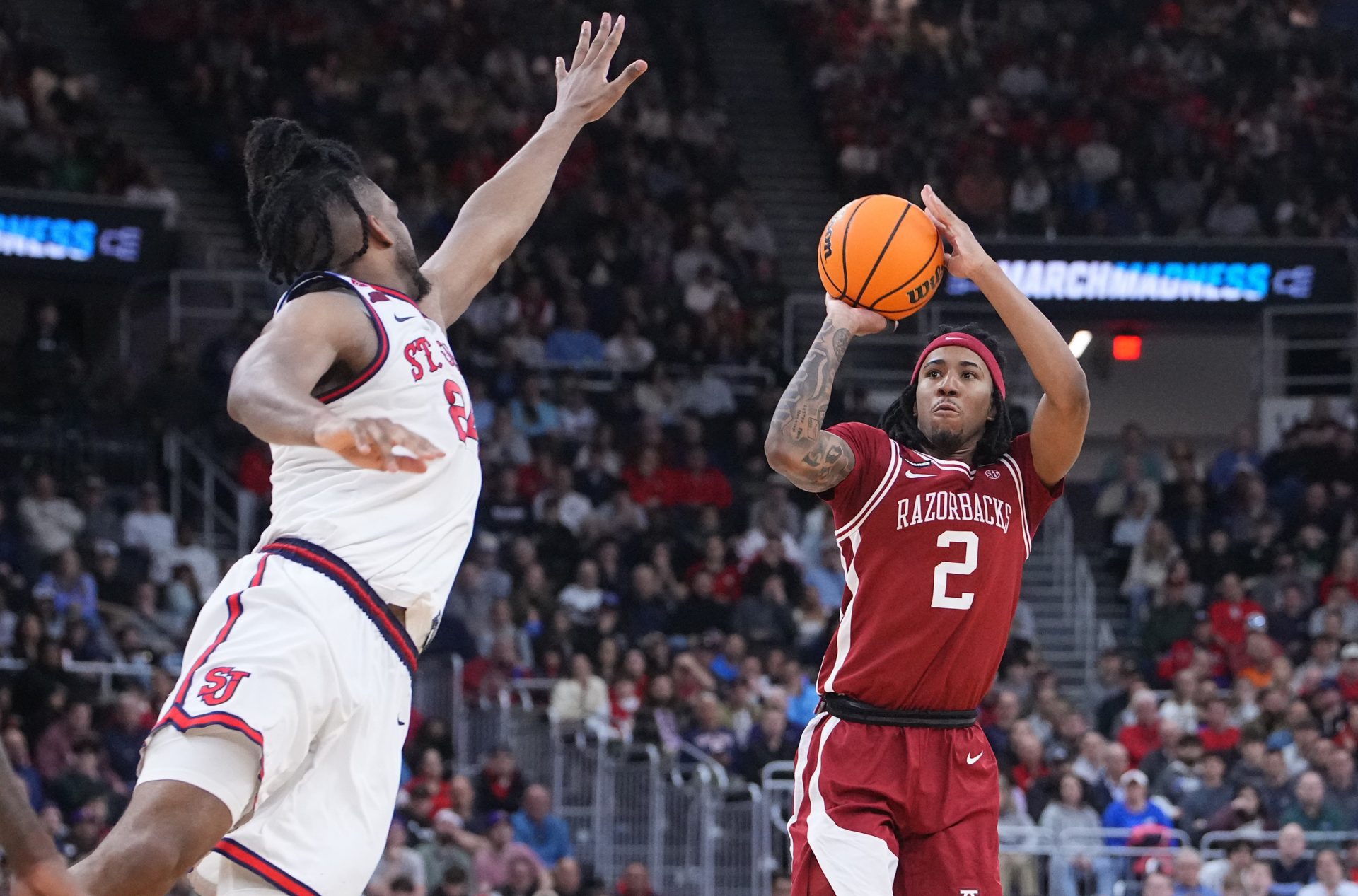 Arkansas Razorbacks guard Boogie Fland (2) shoots against St. John's Red Storm forward Zuby Ejiofor (24) during the second half of a second round men’s NCAA Tournament game at Amica Mutual Pavilion.