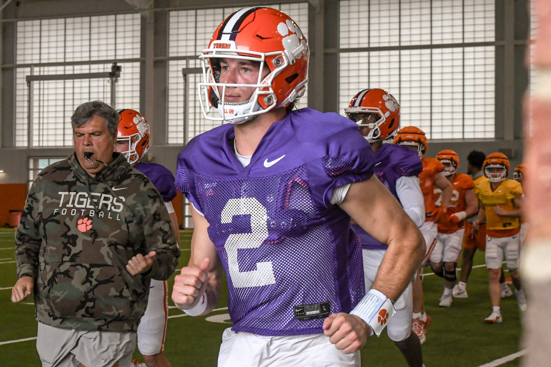 Clemson quarterback Cade Klubnik (2) runs to the outdoor fields with teammates and coaches during Spring Practice