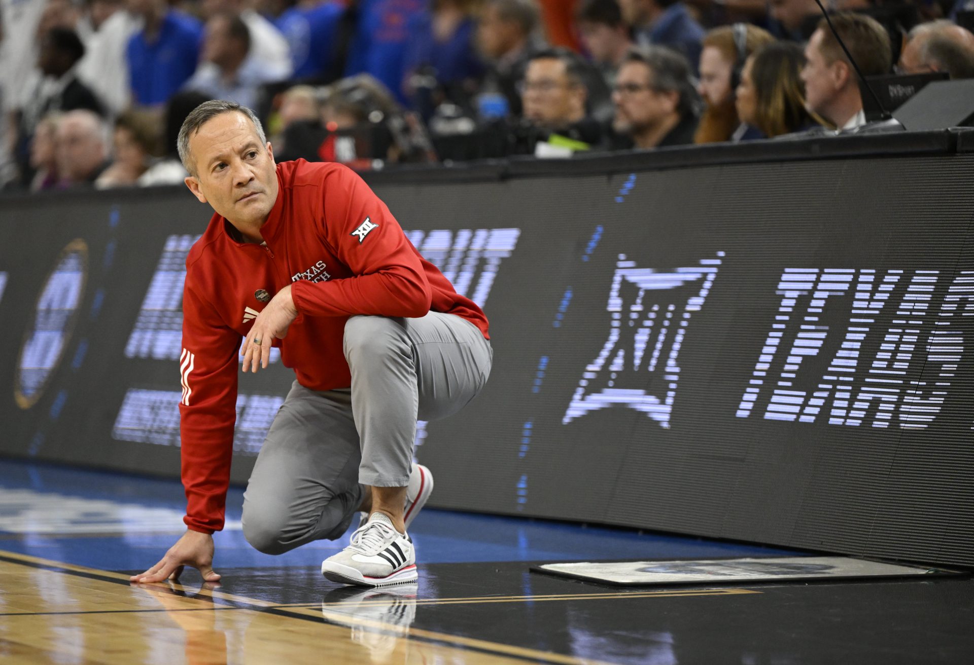 Texas Tech Red Raiders head coach Grant McCasland kneels on the court during the second half against the Florida Gators during the West Regional final of the 2025 NCAA tournament at Chase Center.