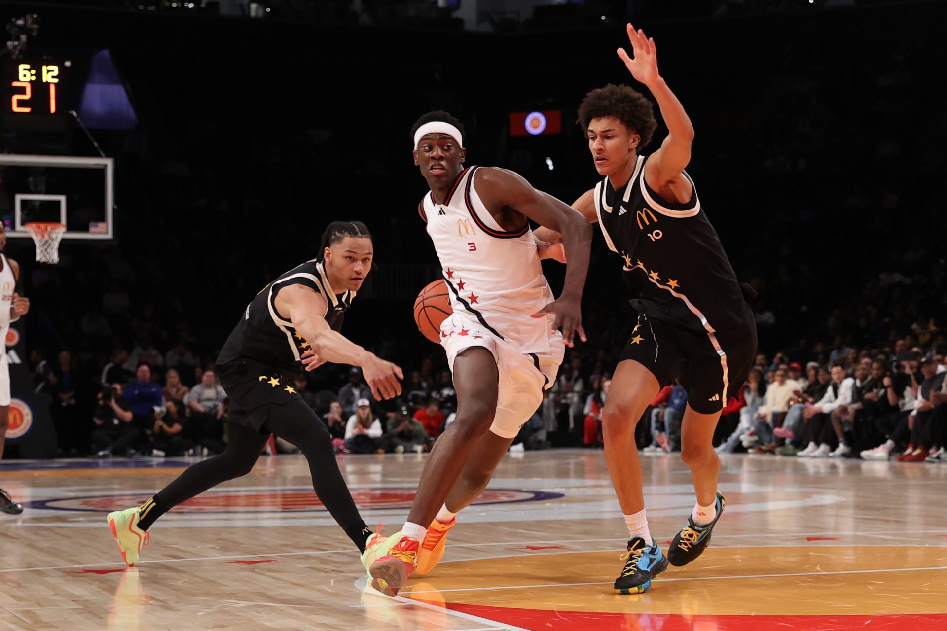 McDonald's All American West forward AJ Dybantsa (3) drives to the basket against McDonald's All American East guard Zai Harwell (0) and McDonald's All American East forward Nate Ament (10) during the first half of the game at Barclays Center.