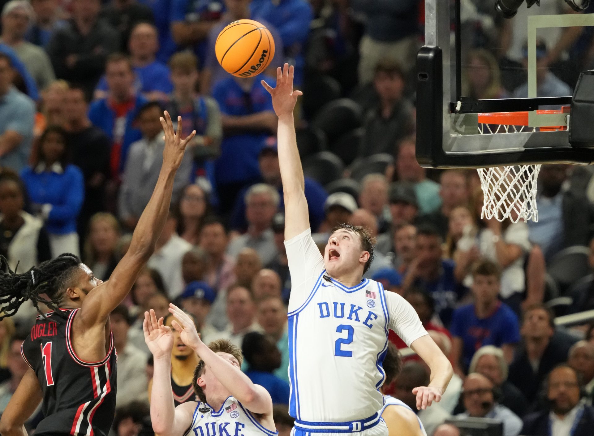 Duke Blue Devils forward Cooper Flagg (2) and Houston Cougars forward Joseph Tugler (11) battle for the ball in the semifinals of the men's Final Four of the 2025 NCAA Tournament at the Alamodome.