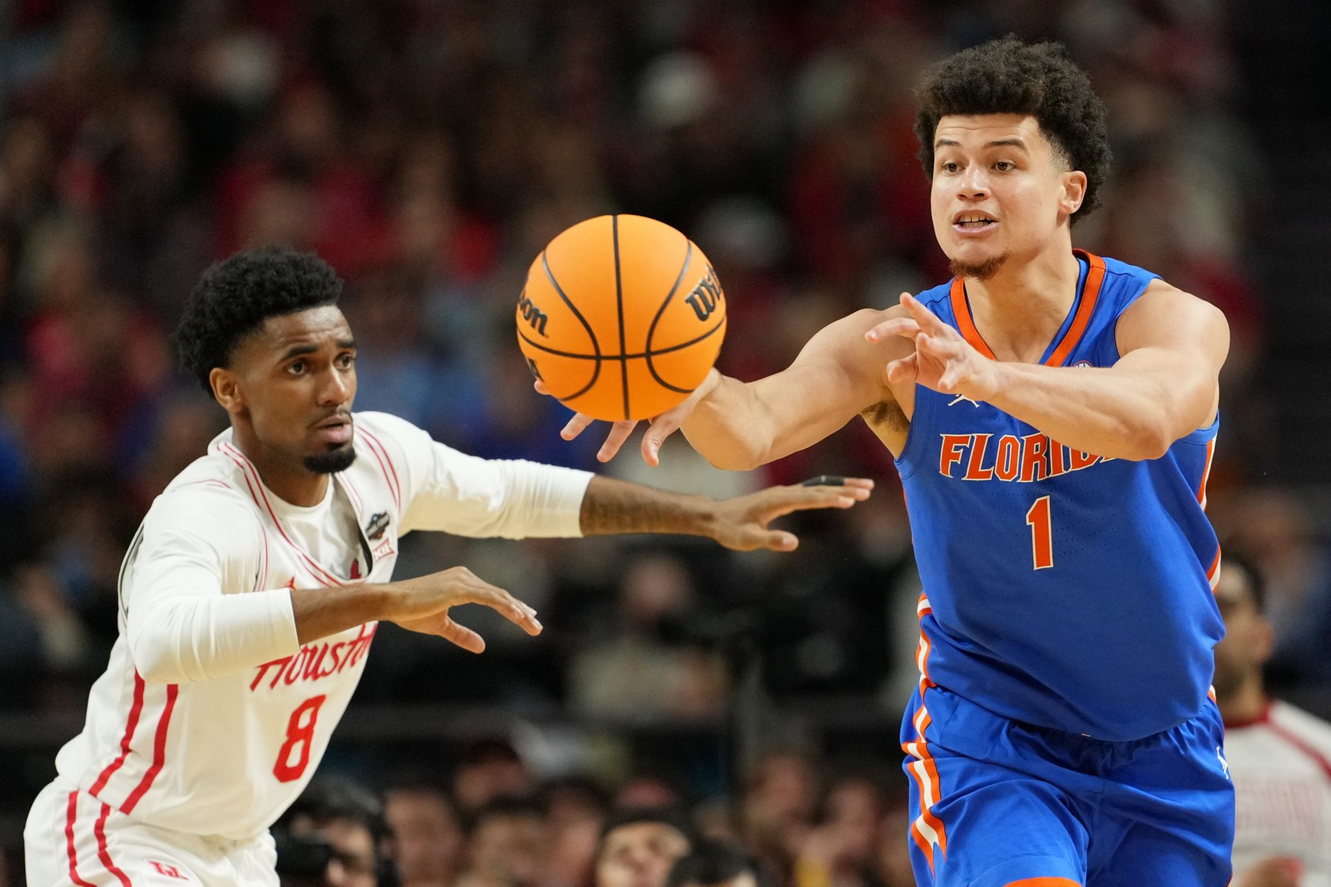 Florida Gators guard Walter Clayton Jr. (1) passes the ball against Houston Cougars guard Mylik Wilson (8) during the first half of the national championship game of the Final Four of the 2025 NCAA Tournament at the Alamodome.