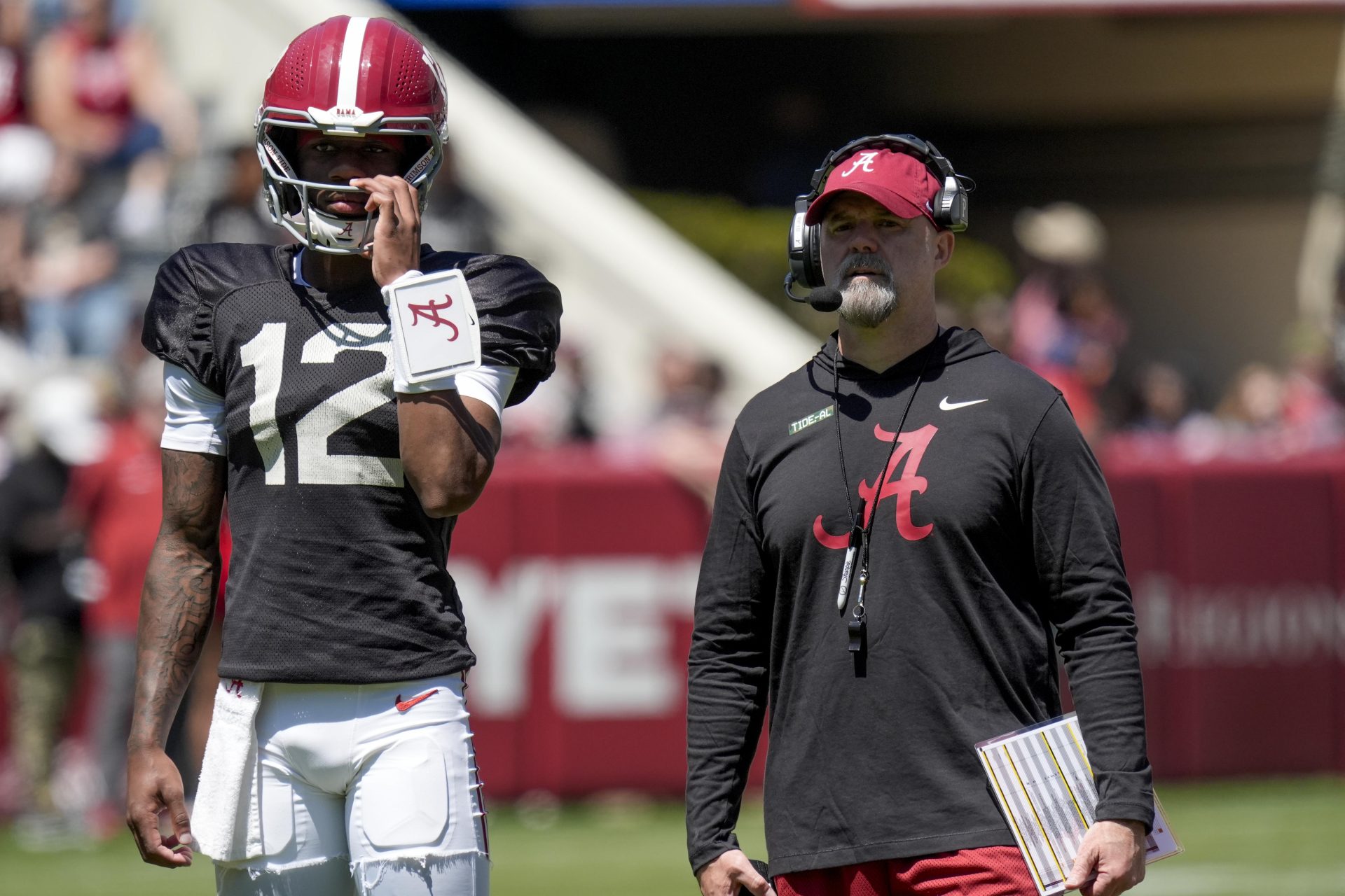 Alabama quarterback Keelon Russell (12) stands with Alabama offensive coordinator Ryan Grubb during A-Day drills at Bryant-Denny Stadium.