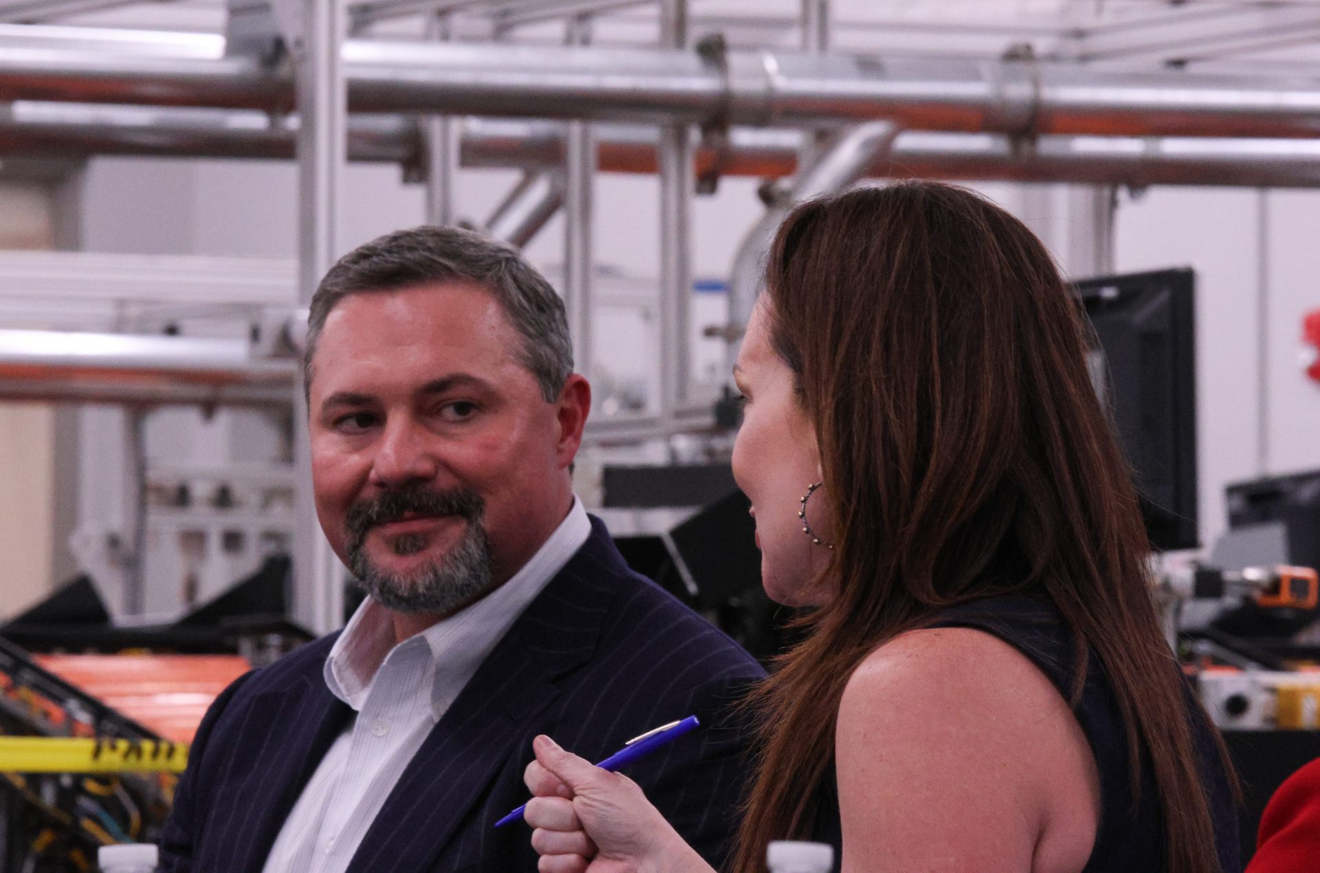 Texas Tech University System Board of Regents Chairman Cody Campbell listens to U.S. Department of Agriculture Secretary Brooke Rollins speak to other Texas Tech leaders at the USDA Agricultural Marketing Service Cotton Classification Complex