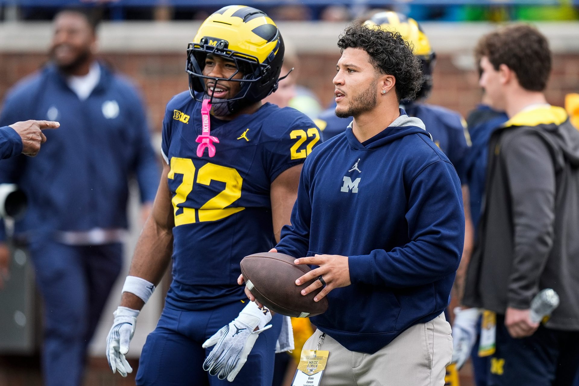 Former Michigan running back Blake Corum talks to running back Justice Haynes (22) at warm up before the spring game at Michigan Stadium in Ann Arbor on Saturday, April 19, 2025.