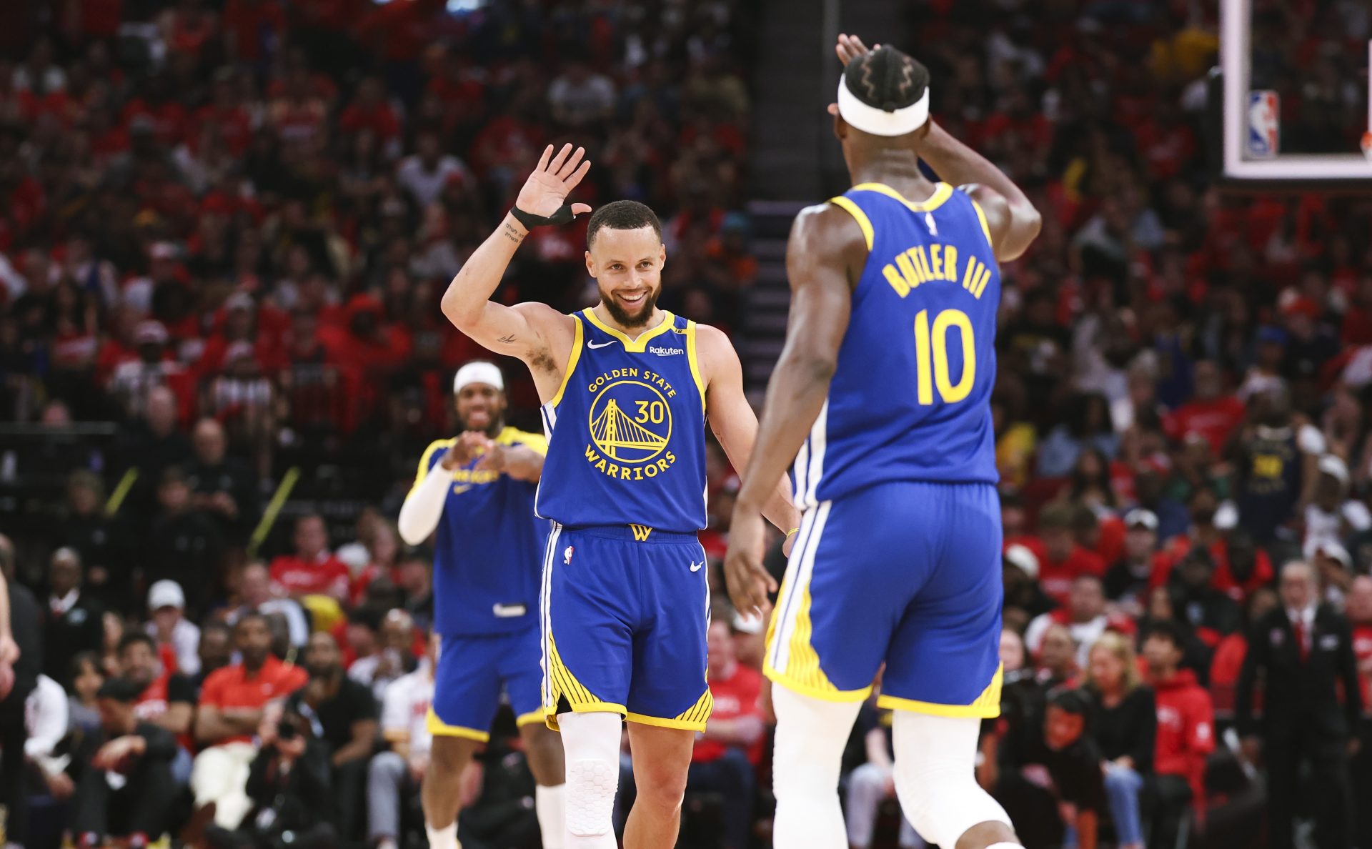 Golden State Warriors guard Stephen Curry (30) celebrates with forward Jimmy Butler III (10) after a play during the third quarter against the Houston Rockets at Toyota Center.