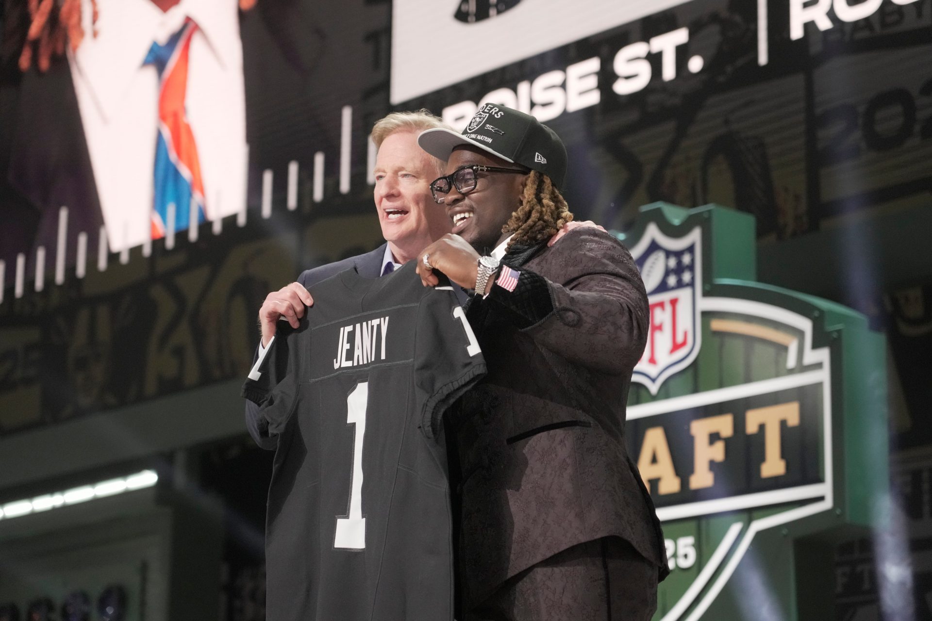 NFL Commissioner Rodger Goodell, left, with Boise State Broncos running back Ashton Jeanty is selected by the Las Vegas Raiders as the number six pick in the first round of the 2025 NFL Draft at Lambeau Field.