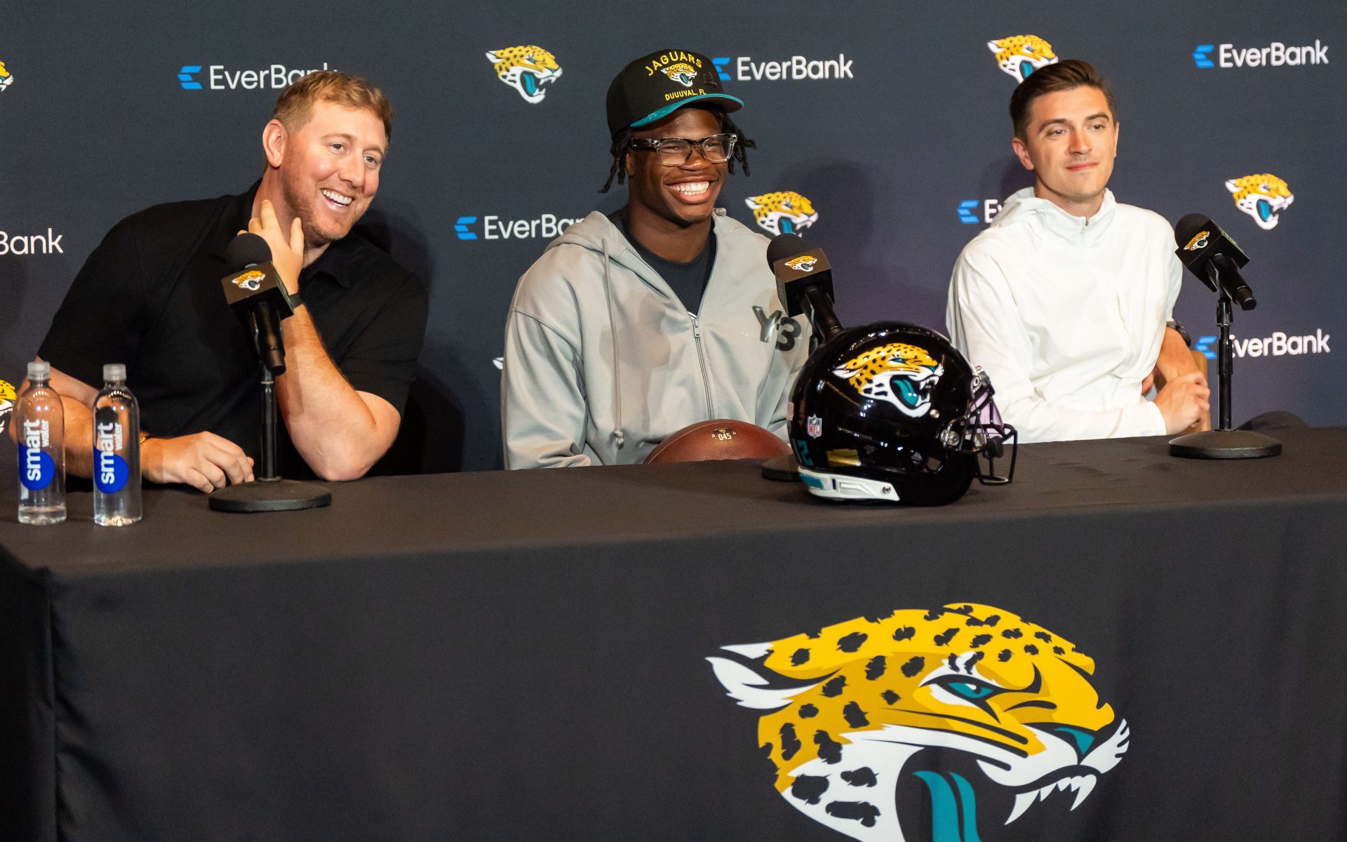 Jacksonville Jaguars ead Coach Liam Coen, left, has a laugh with Jacksonville Jaguars’ first-round pick, Colorado Buffaloes wide receiver and defensive back Travis Hunter, center, during a press conference Friday, March 25, 2025 at Miller Electric Center in Jacksonville, Fla. with General Manager James Gladstone, right.