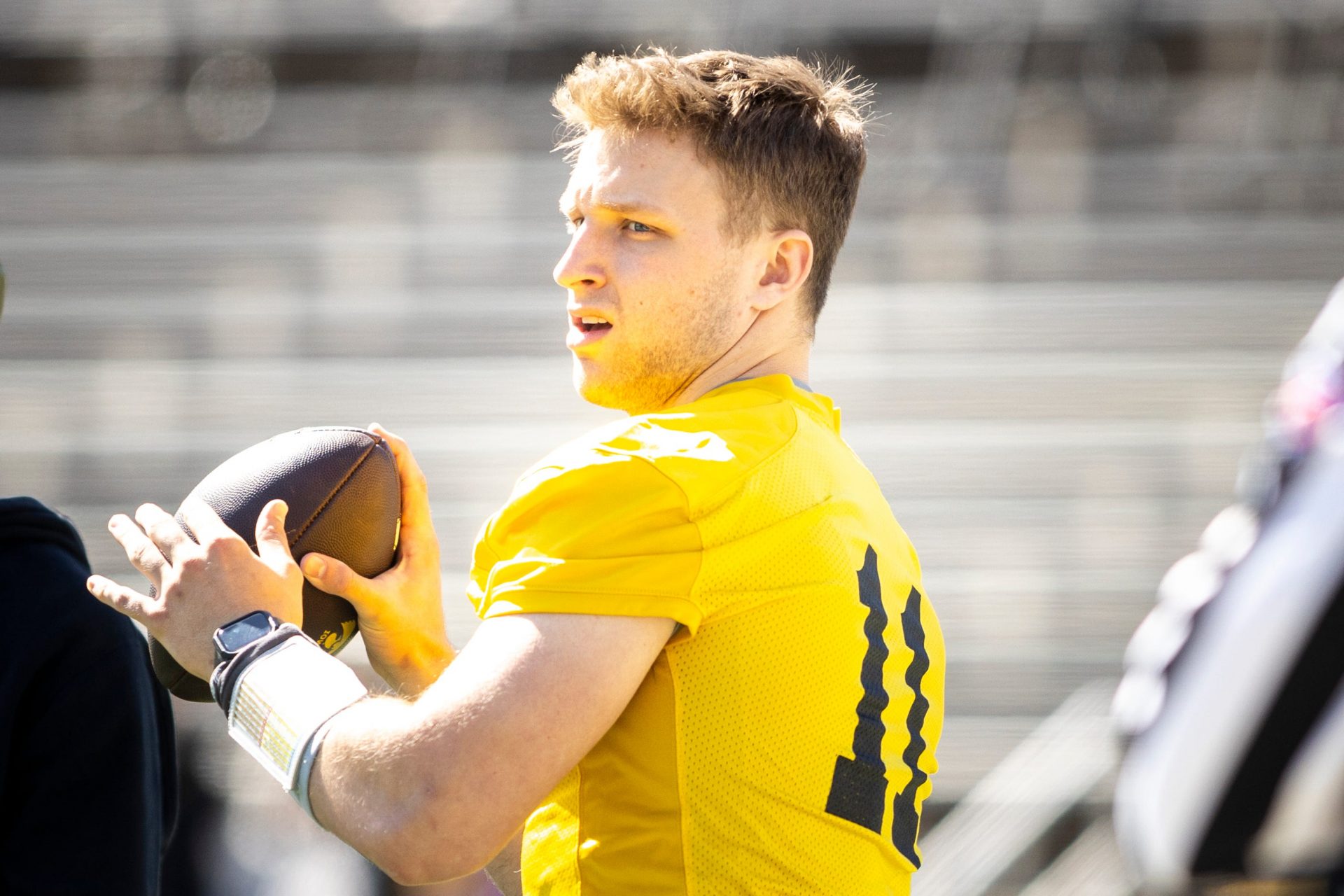 Iowa quarterback Mark Gronowski (11) throws during a spring NCAA football open practice at Kinnick Stadium.