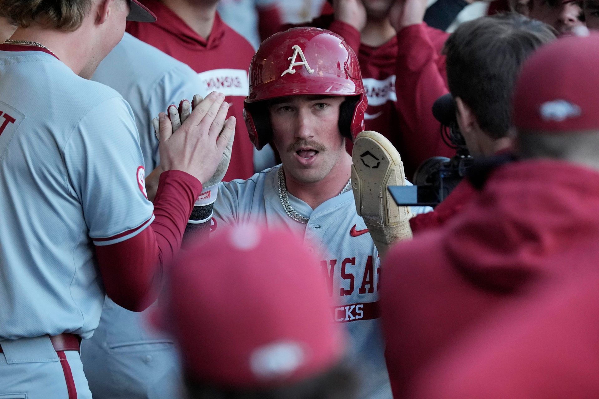 Arkansas outfielder Logan Maxwell (22) celebrates after scoring a run during a NCAA baseball game against Georgia
