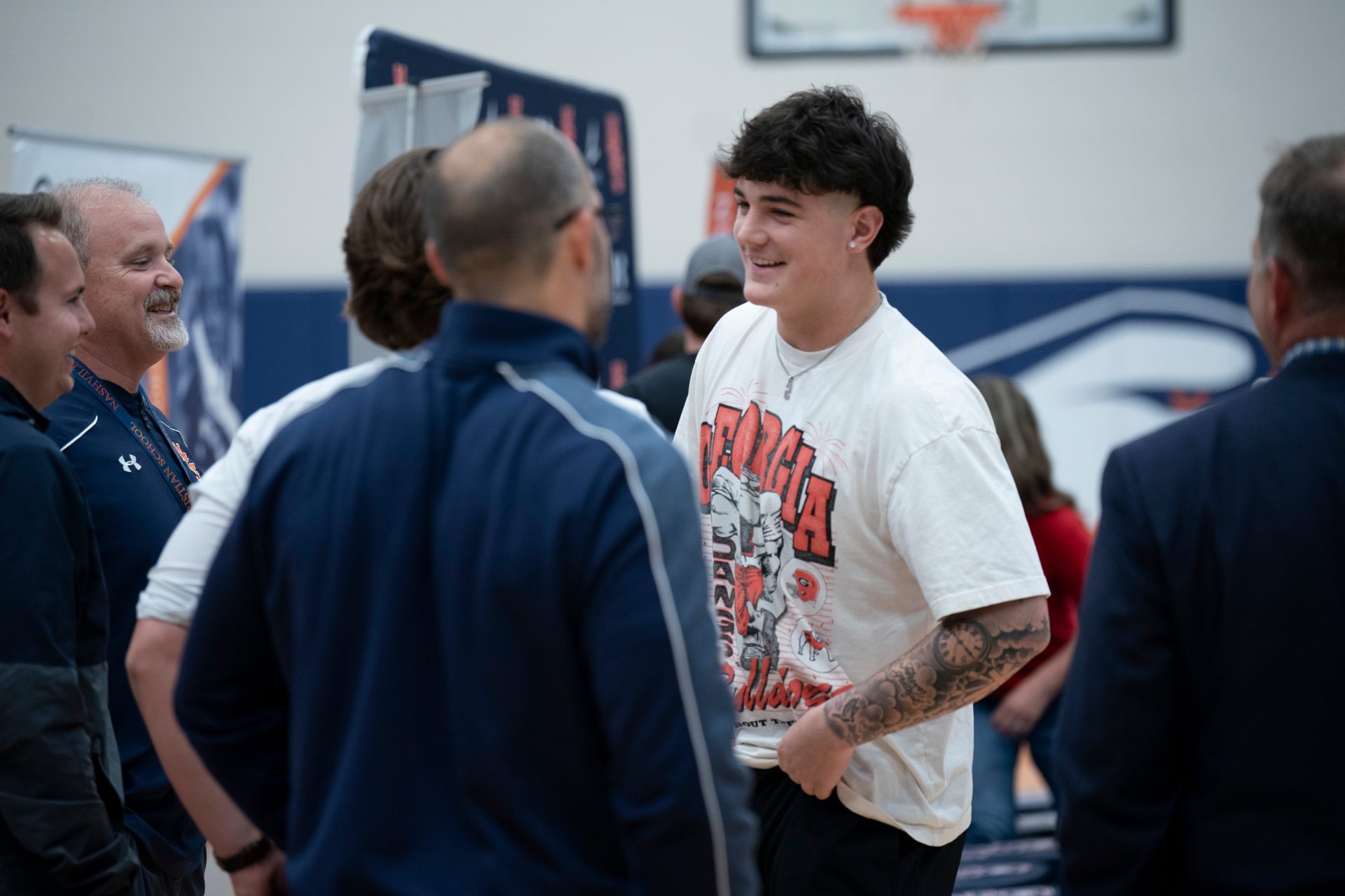 Nashville Christian's five-star quarterback Jared Curtis speaks with coaches after announcing his decision to sign with Georgia at Nashville Christian School in Nashville, Tenn