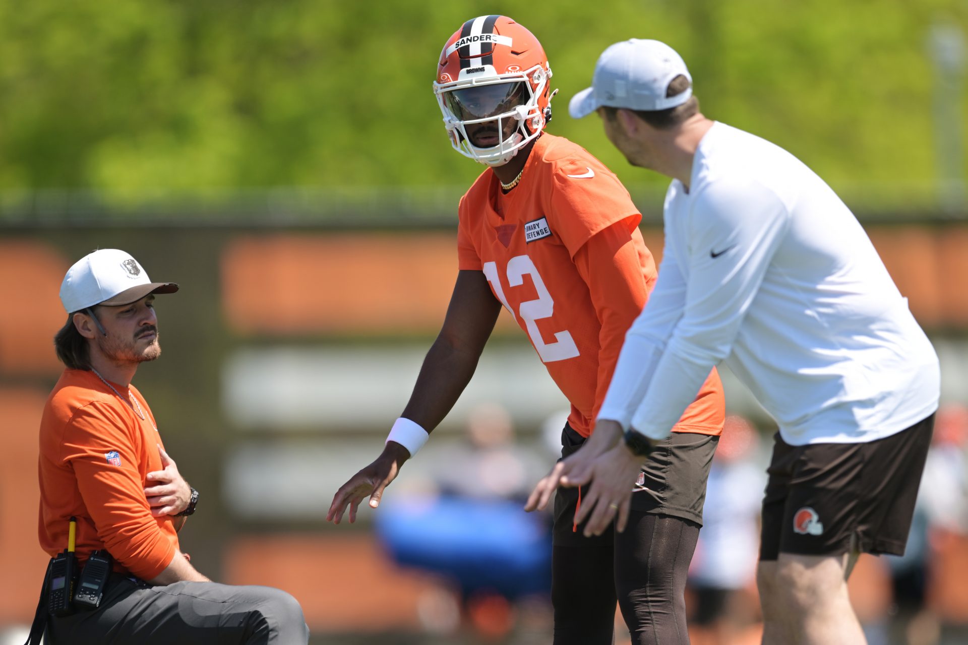 Cleveland Browns quarterback Shedeur Sanders (12) listens to offensive coordinator Tommy Rees during rookie minicamp at CrossCountry Mortgage Campus.