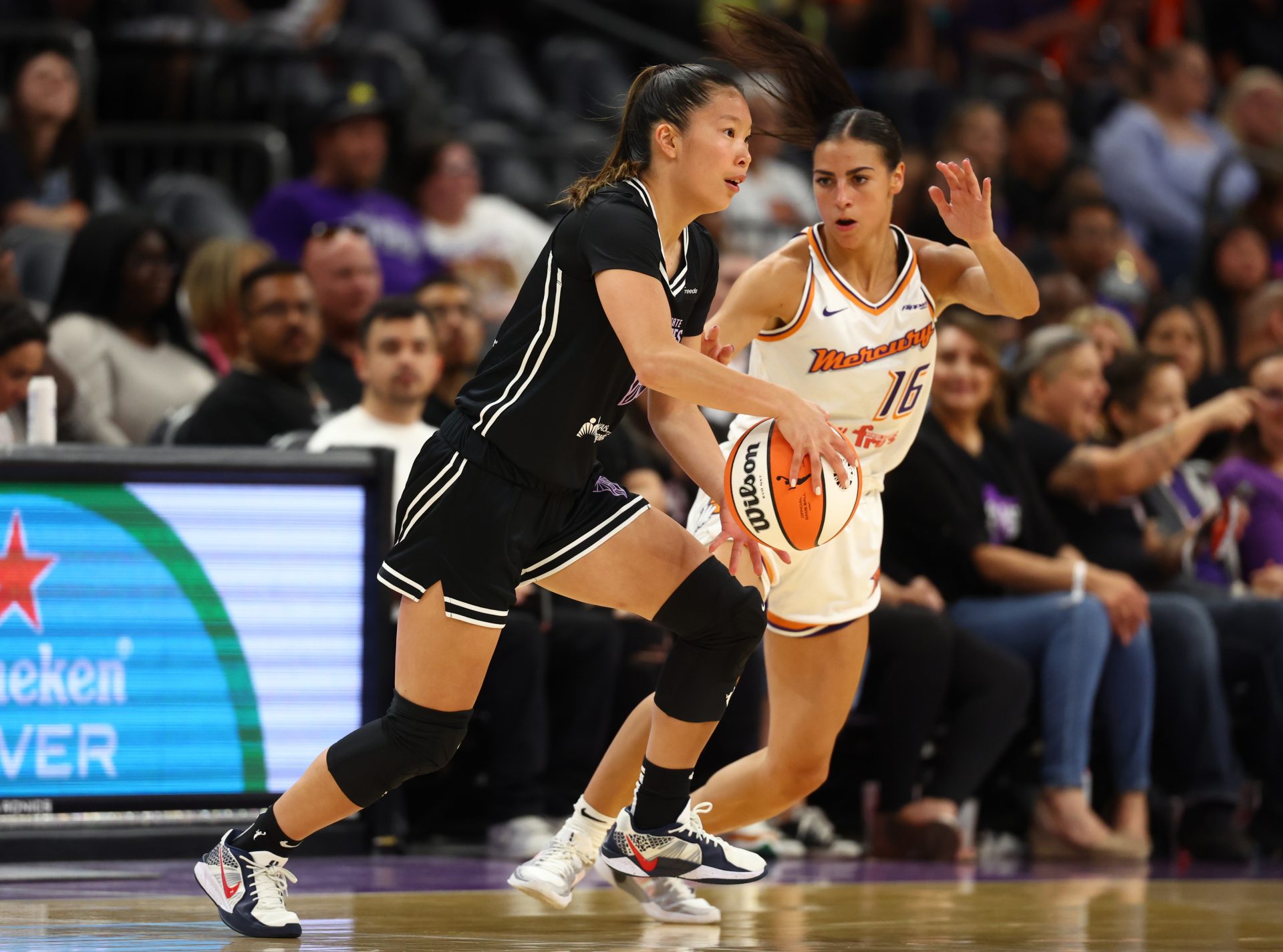 Golden State Valkyries guard Kaitlyn Chen (2) against Phoenix Mercury guard Megan McConnell (16) during a preseason game at PHX Arena.