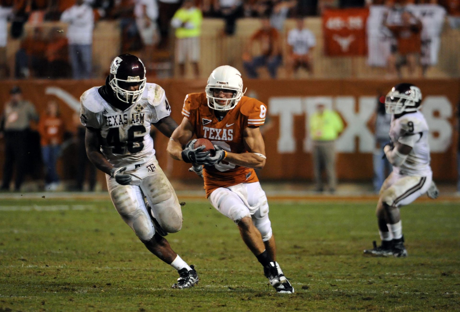 Texas Longhorns wide receiver Jordan Shipley (8) carries the ball pursued by Texas A&M Aggies linebacker Matt Featherston (46) in the third quarter at Darrell K Royal-Texas Memorial Stadium. Texas beat Texas A&M 49-9.