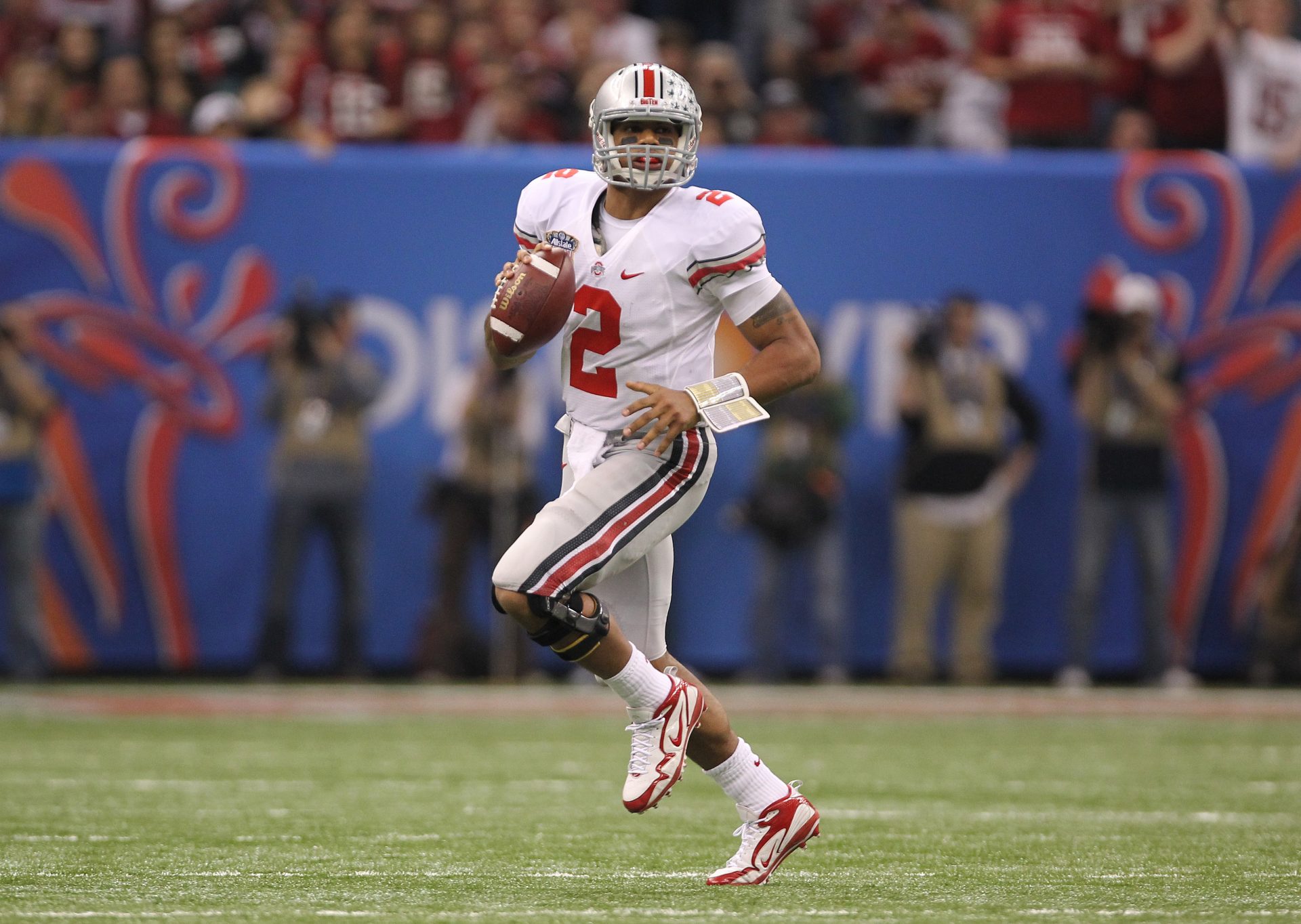 Ohio State Buckeye quarterback Terrelle Pryor (2) scrambles against the Arkansas Razorbacks during the 2011 Sugar Bowl at the Louisiana Superdome .