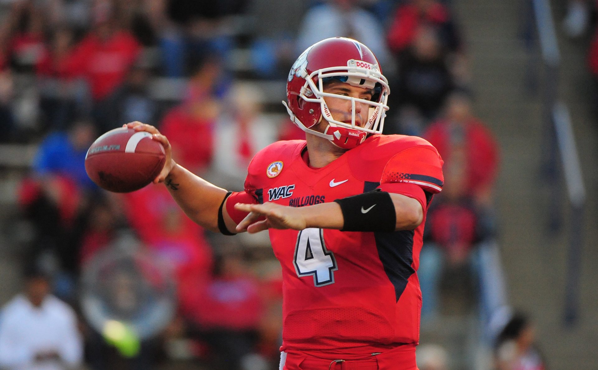 Fresno State Bulldogs quarterback Derek Carr (4) passes the ball during the first quarter against the Boise State Broncos at Bulldog Stadium.