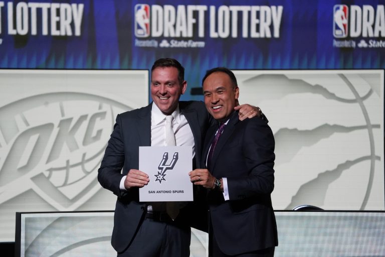 NBA Deputy Commissioner Mark Tatum (right) congratulates San Antonio Spurs managing partner Peter J. Holt (left) the first pick in the 2023 NBA Draft Lottery at McCormick Place West.