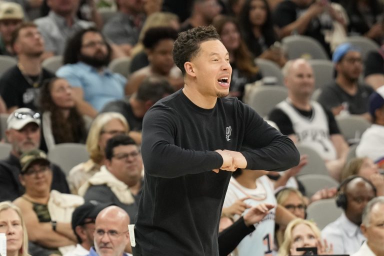 San Antonio Spurs interim coach Mitch Johnson signals to players during the second half against the Toronto Raptors at Frost Bank Center.