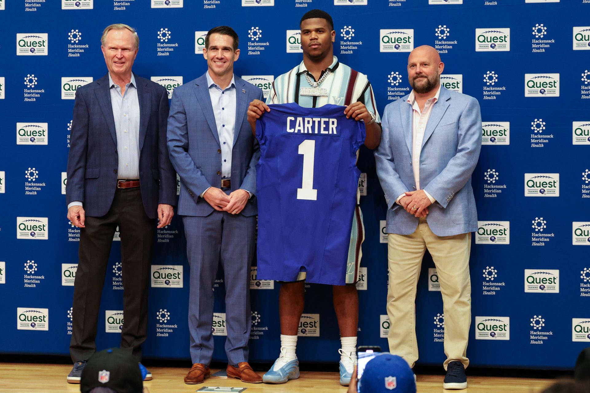 New York Giants president John Mara (far left), general manager Joe Schoen (left), Abdul Carter, and head coach Brian Daboll (right) pose for photos prior to the start of the press conference to introduce the Giants first round draft picks.