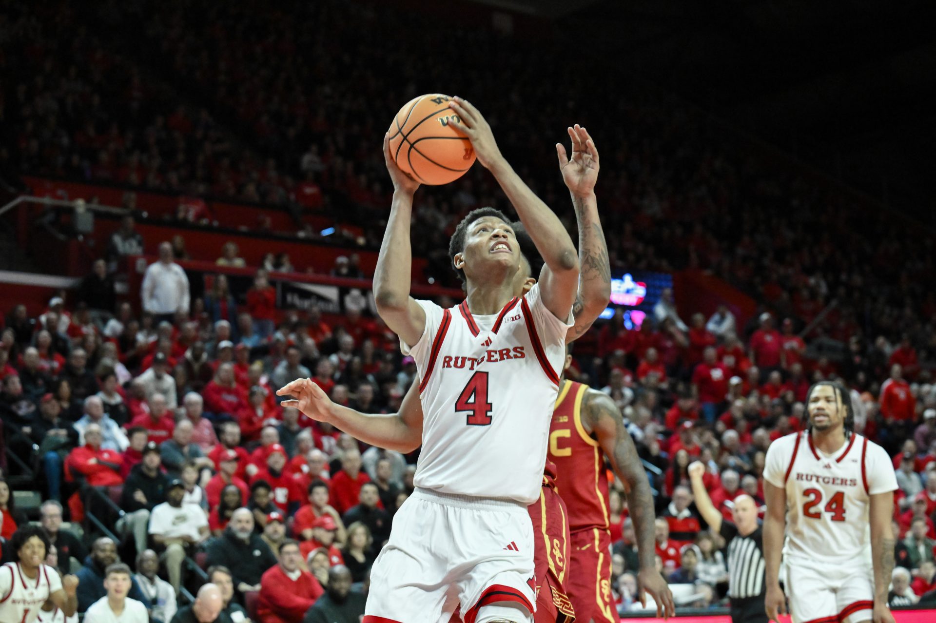 Rutgers Scarlet Knights guard Ace Bailey (4) shoots the ball while being defended by USC Trojans guard Bryce Pope (4) during the second half at Jersey Mike's Arena.