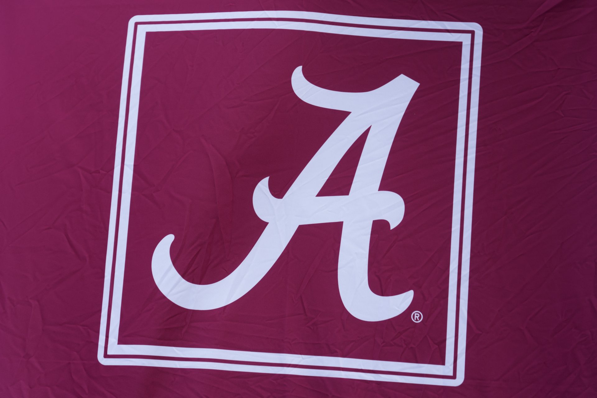 General view of the Alabama Crimson Tide logo on sideline equipment during warmups prior to the game against the Wisconsin Badgers at Camp Randall Stadium