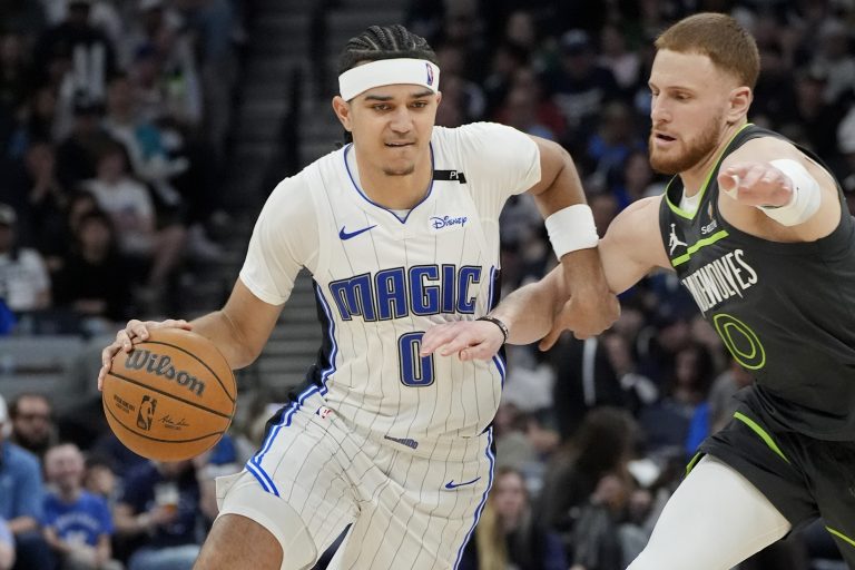 Orlando Magic guard Anthony Black (0) works around Minnesota Timberwolves guard Donte DiVincenzo (0) in the third quarter at Target Center.