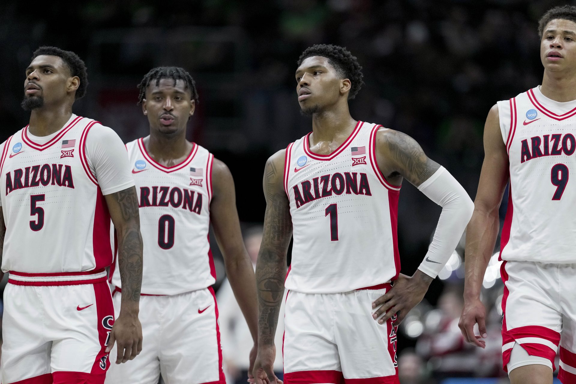 Members of the Arizona Wildcats stand on the court against the Oregon Ducks in the second half at Climate Pledge Arena.