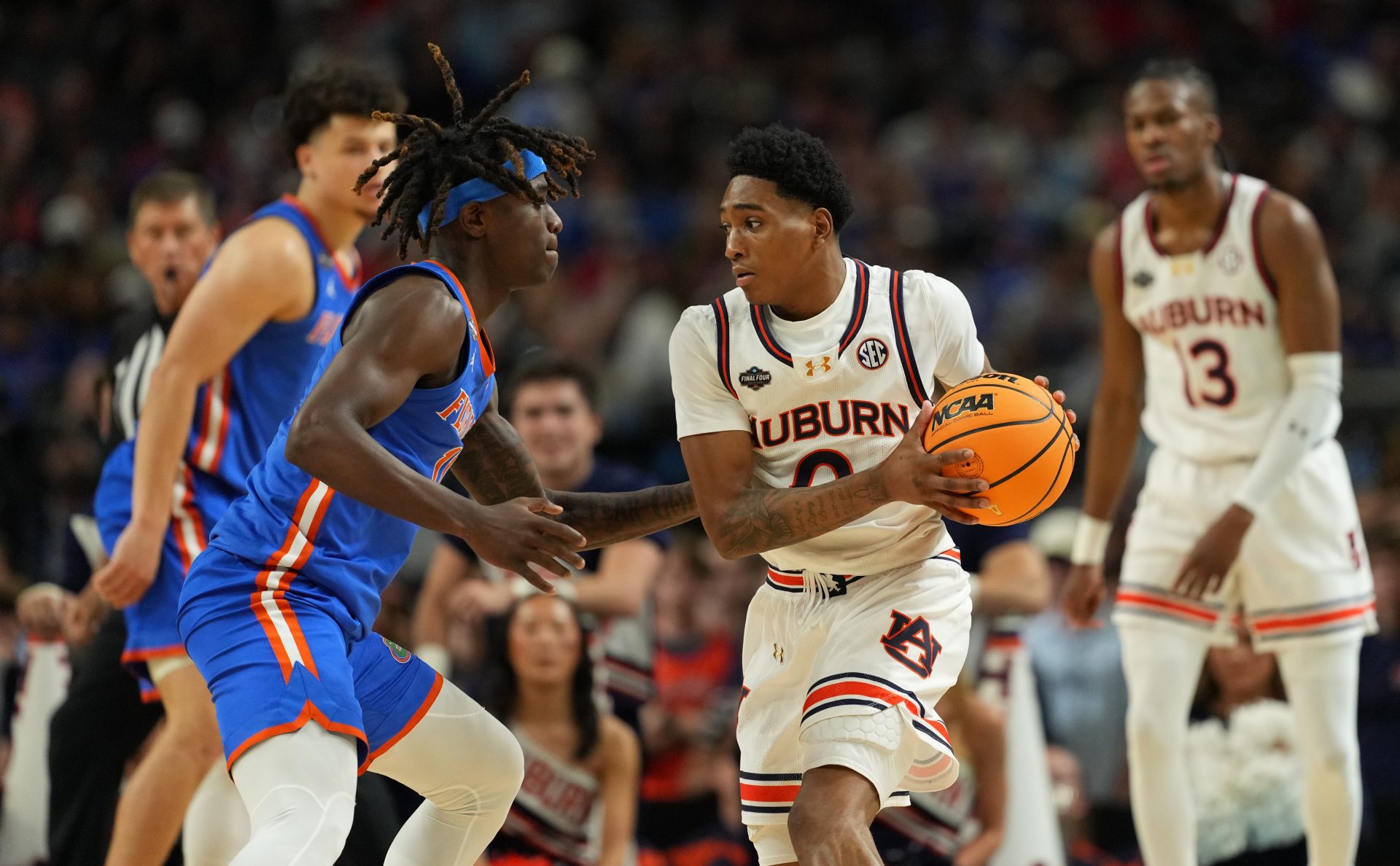 Auburn Tigers guard Tahaad Pettiford (0) controls the ball against Florida Gatorsguard Denzel Aberdeen (11) during the second half in the semifinals of the men's Final Four of the 2025 NCAA Tournament at the Alamodome.