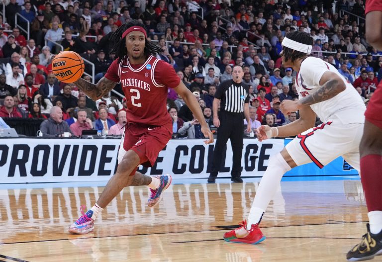 Arkansas Razorbacks guard Boogie Fland (2) dribbles against St. John's Red Storm guard Aaron Scott (0) during the second half of a second round men’s NCAA Tournament game at Amica Mutual Pavilion.