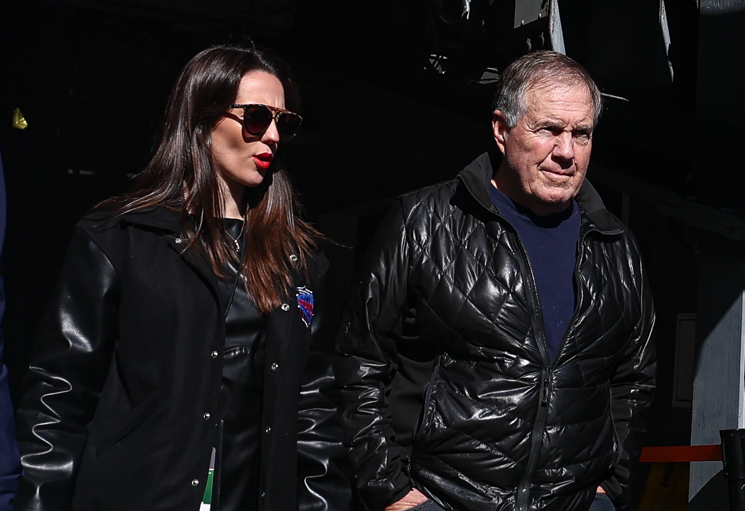 Former New England Patriots head coach Bill Belichick and girlfriend Jordon Hudson enter the field before the game between the Notre Dame Fighting Irish and the Navy Midshipmen at MetLife Stadium.