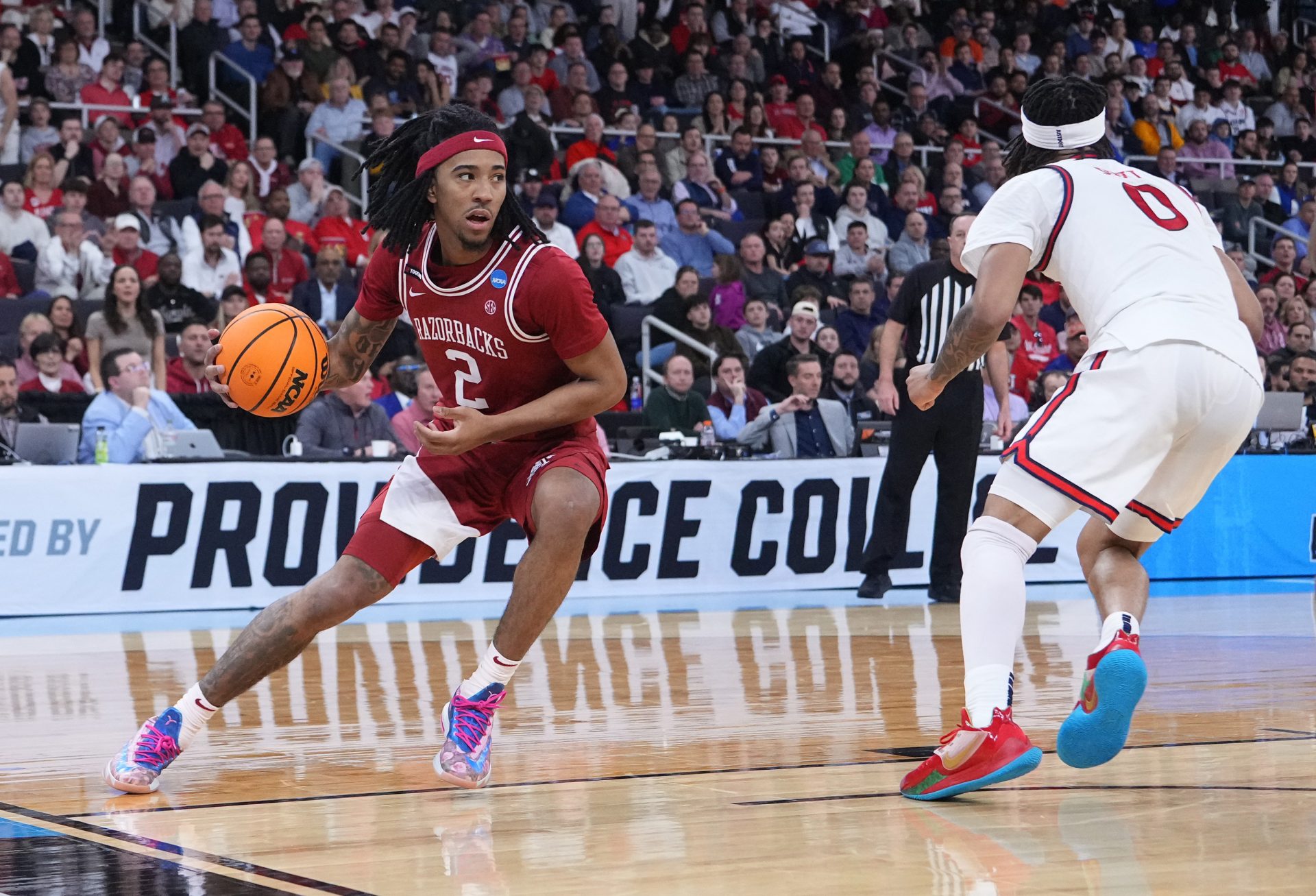 Arkansas Razorbacks guard Boogie Fland (2) dribbles against St. John's Red Storm guard Aaron Scott (0) during the second half of a second round men’s NCAA Tournament game at Amica Mutual Pavilion.