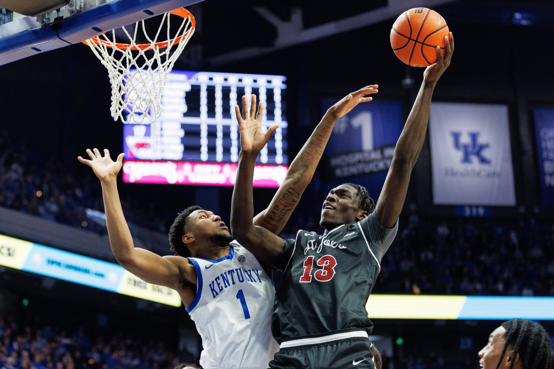 Saint Joseph's Hawks forward Rasheer Fleming (13) goes to the basket against Kentucky Wildcats guard Justin Edwards (1) during the first half at Rupp Arena at Central Bank Center.